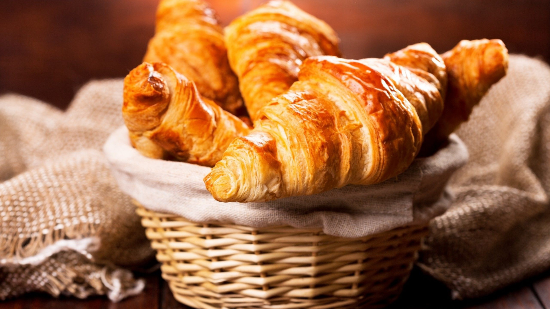 Croissant: Displayed in bakery shop windows, Golden, flaky appearance. 1920x1080 Full HD Wallpaper.