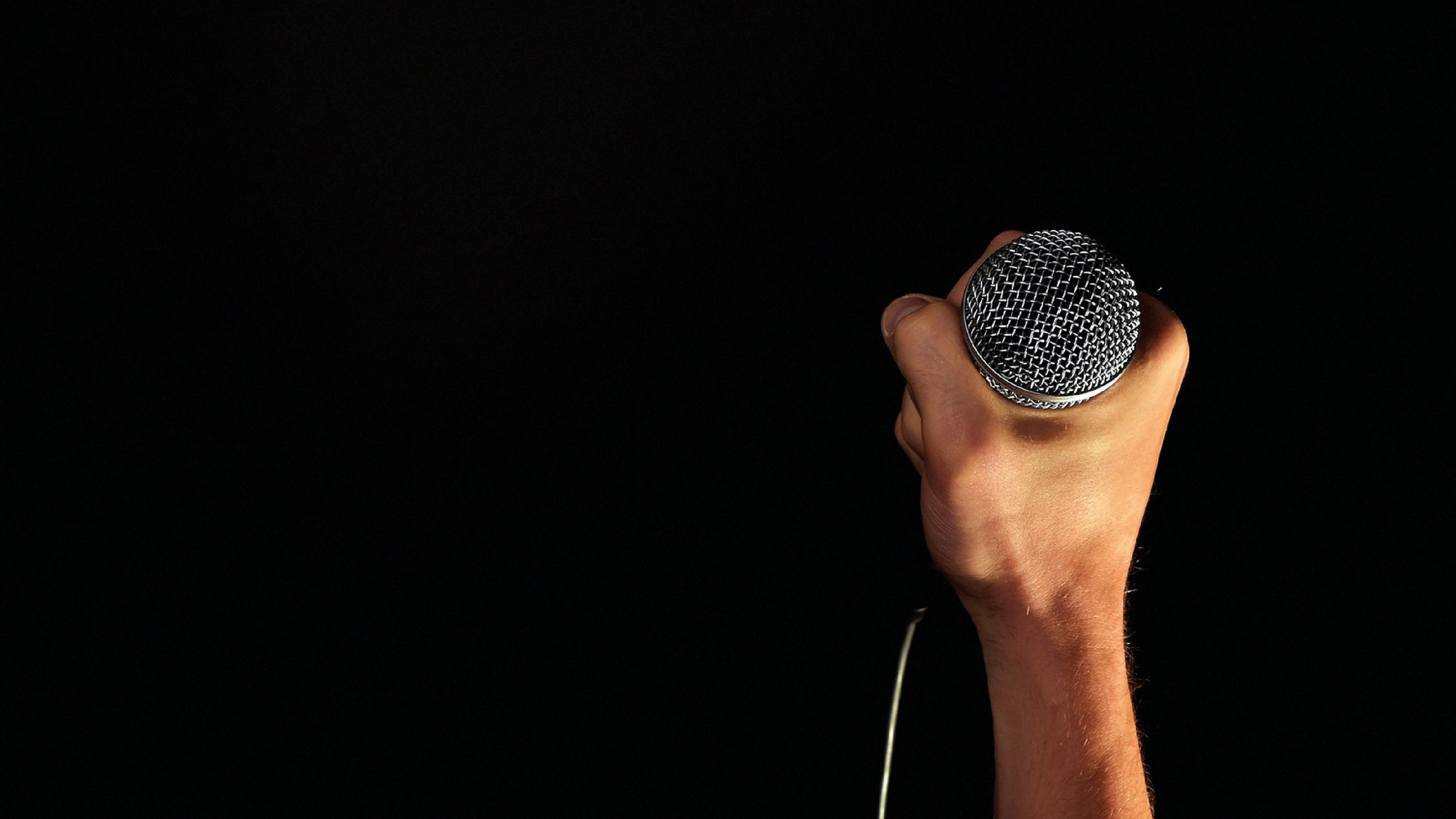 Hand holding microphone, Acoustic music vibes, HD widescreen display, Immersive experience, 3840x2160 4K Desktop