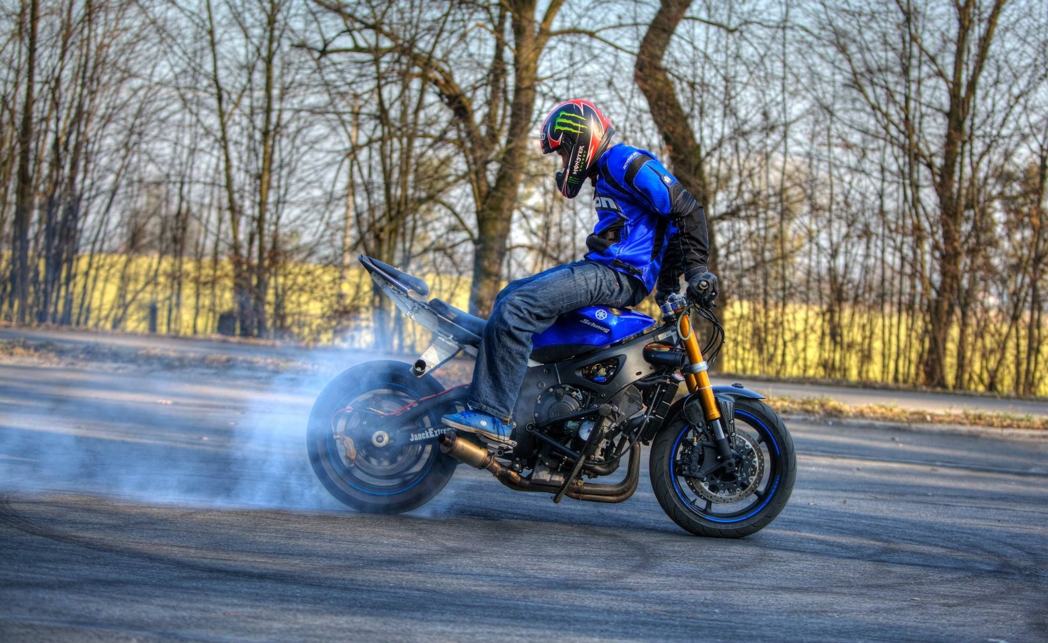 Stunt: Burnout by a stuntman doing switchback, Motorcycle stunting sport. 2050x1260 HD Background.