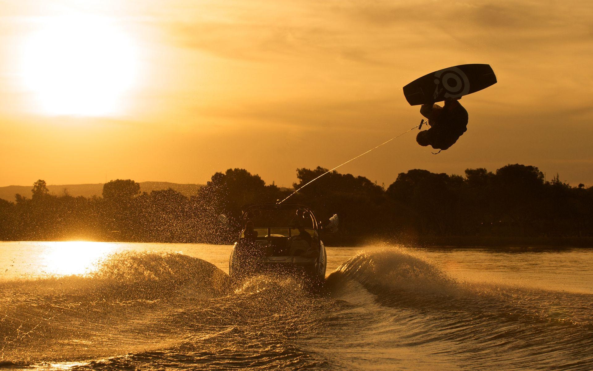 Wakeboarding: Extreme 360 side flip by a pro surfer, Water sports in the sunset. 1920x1200 HD Background.
