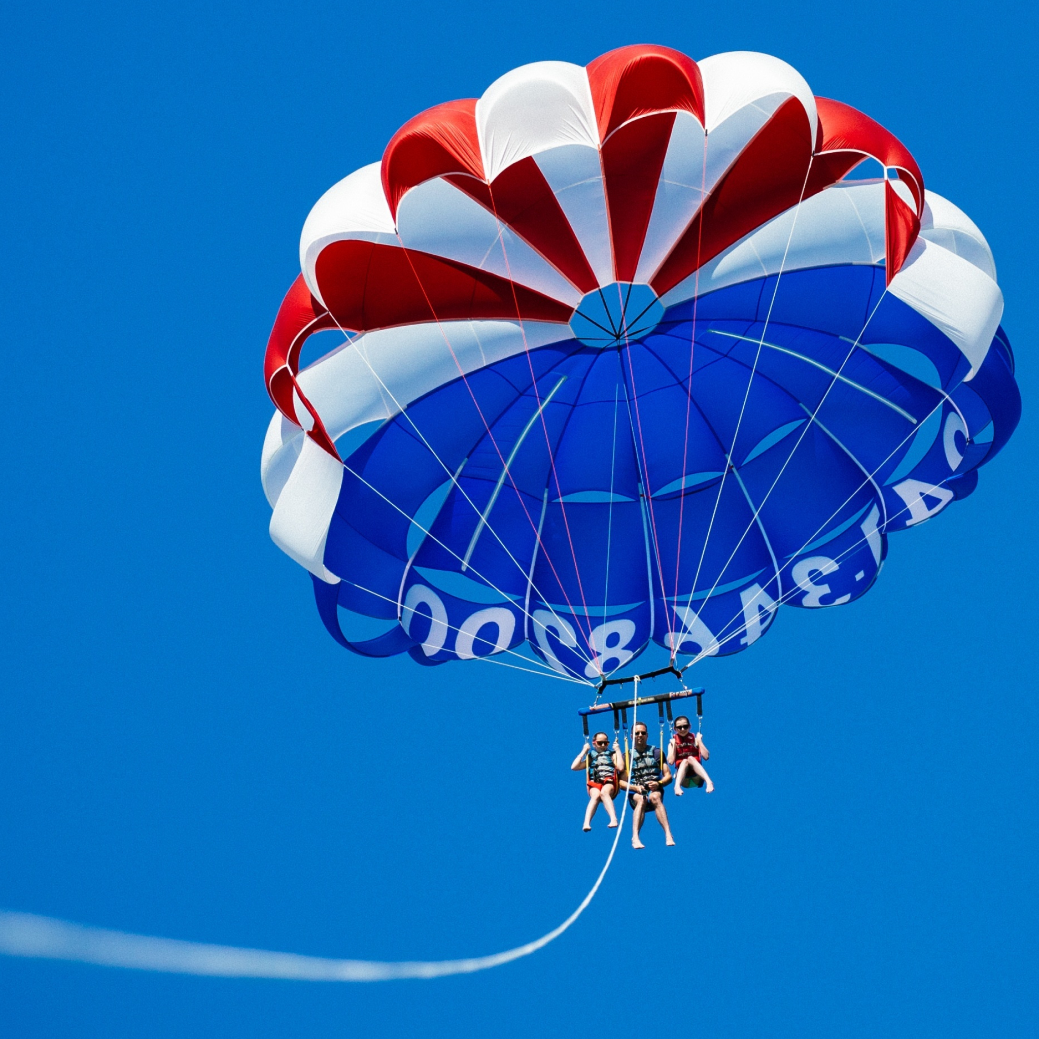 Parasailing: Three people parakiting, The weight limit, The water and wind condition, A parasail wing. 2050x2050 HD Background.