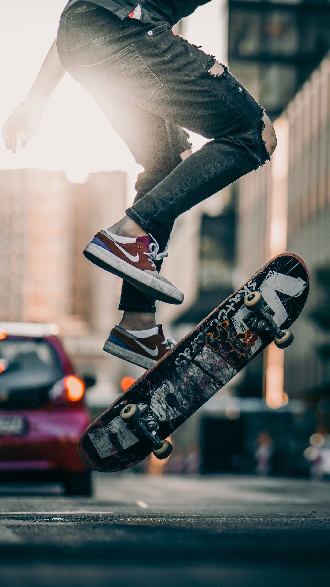 Skateboarding: Exciting street performance involving skateboard tricks and aerial maneuvers. 1080x1920 Full HD Wallpaper.