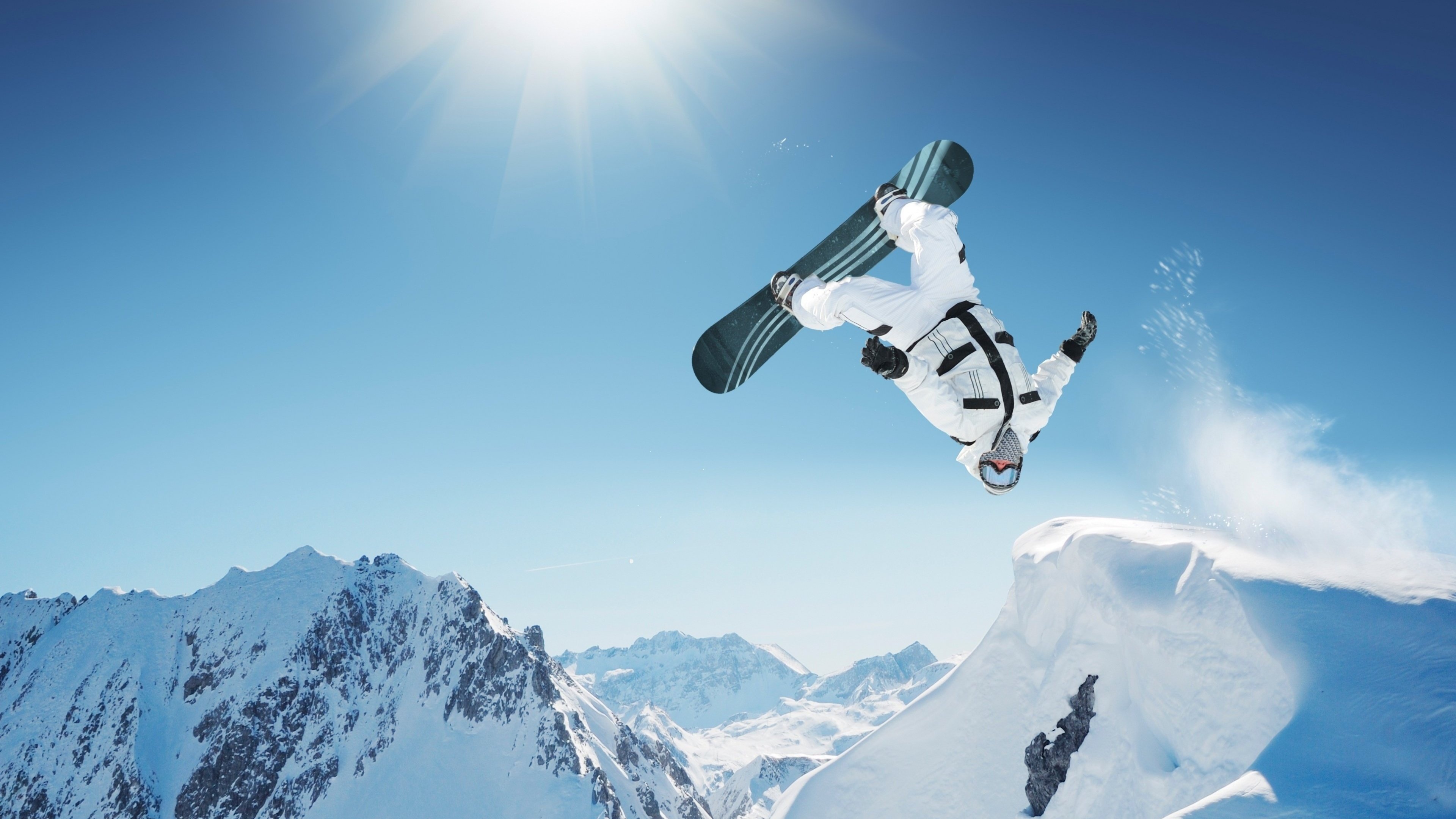 Snowboarding: Big air style in the mountains, High-injury-risk winter sports discipline. 3840x2160 4K Background.