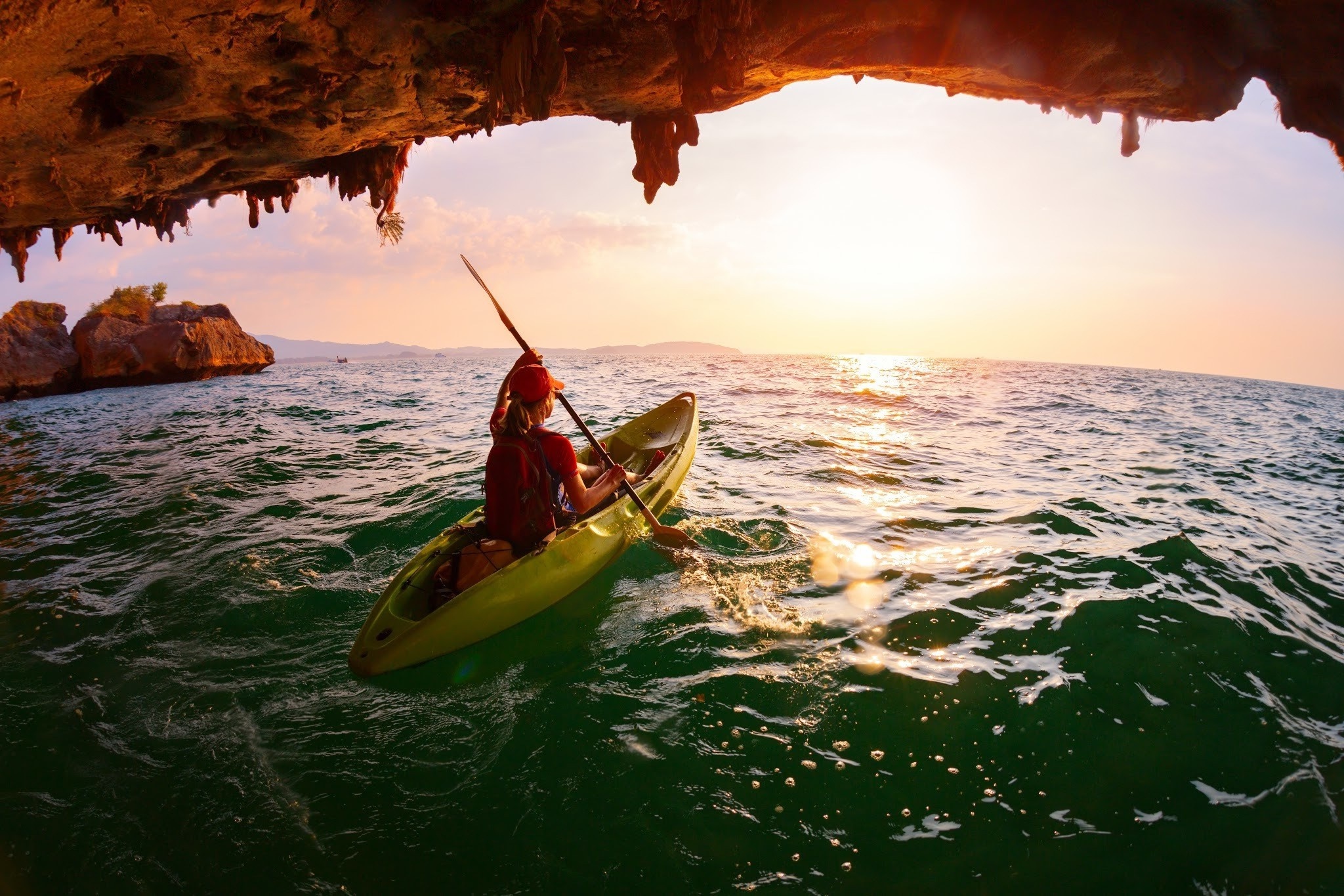 Kayaking: The girl uses a kayak to explore an ocean shore water cave, Outdoor activity and active sport. 2050x1370 HD Wallpaper.