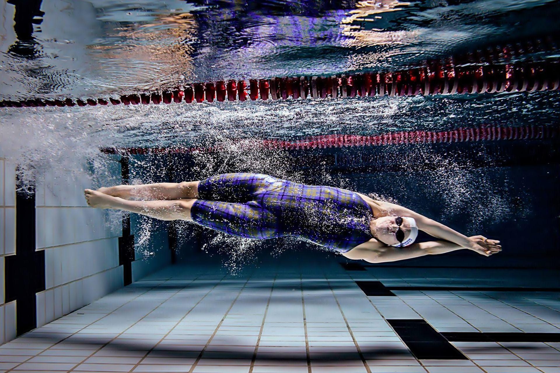 Swimming: An individual or team racing sport that requires the use of one's entire body to move through the water. 1920x1280 HD Background.