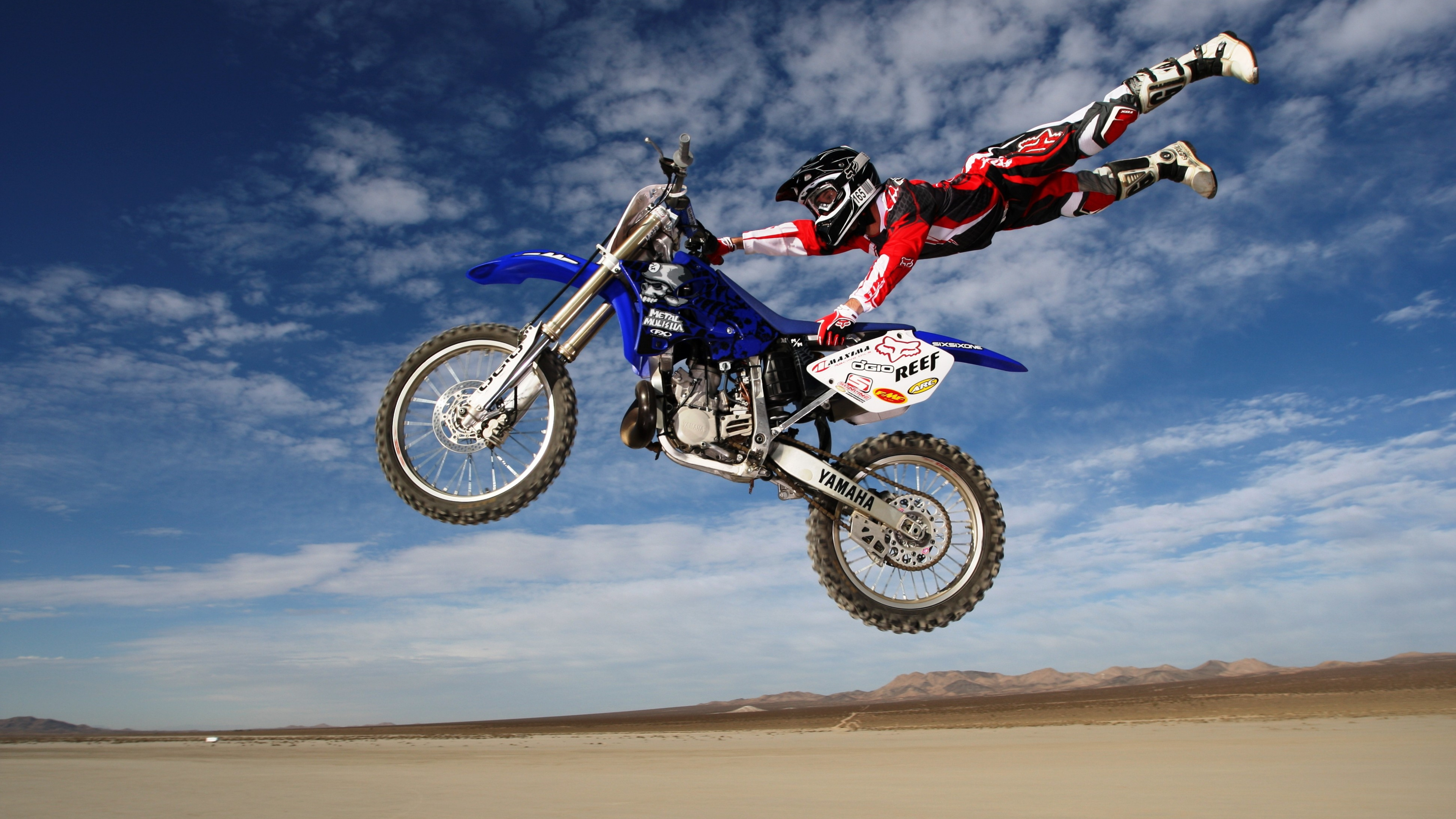 Stunt: Stuntman performing acrobatics in the air on his KTM dirt bike. 3840x2160 4K Wallpaper.