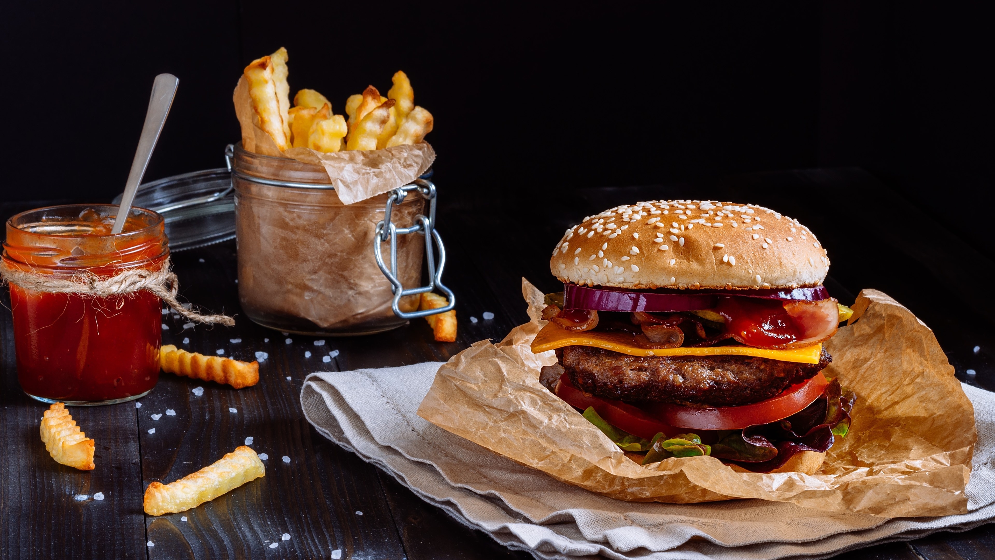 Hamburger: Served with cheese, lettuce, tomato, onion, pickles, bacon, chilis. 3840x2160 4K Background.