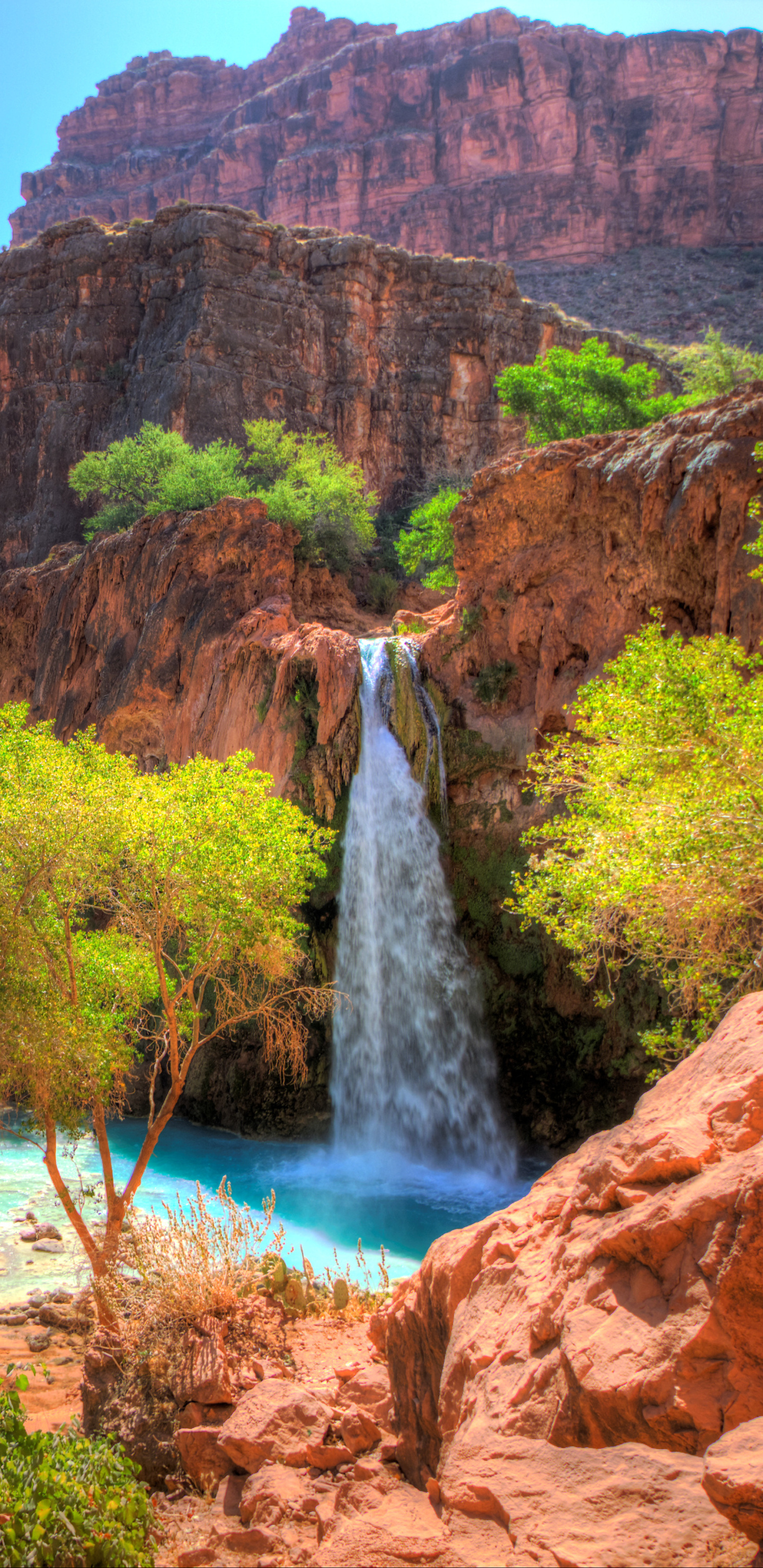 Landscape: A magnificent waterfall in the African-style natural reserve area, Red hills. 1440x2960 HD Background.