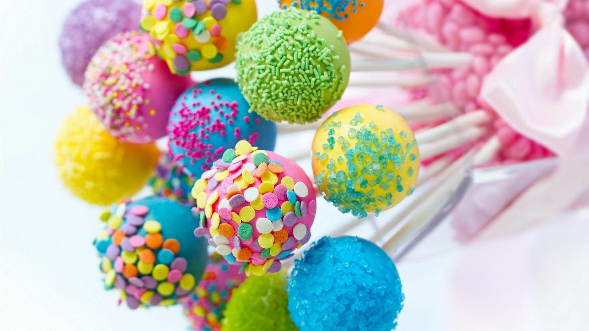 Sweets: A lollipop, A type of sugar candy usually consisting of hard candy mounted on a stick. 1920x1080 Full HD Background.