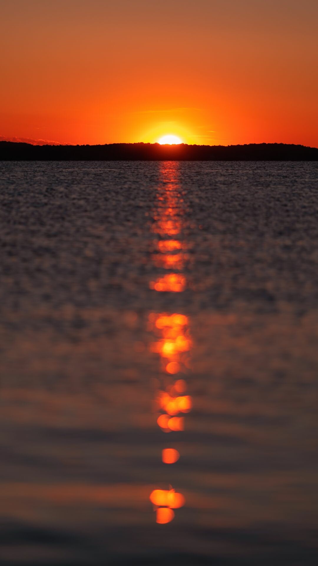Sunset: Dusk, Solar disk crossing the horizon, Atmospheric phenomena. 1080x1920 Full HD Background.