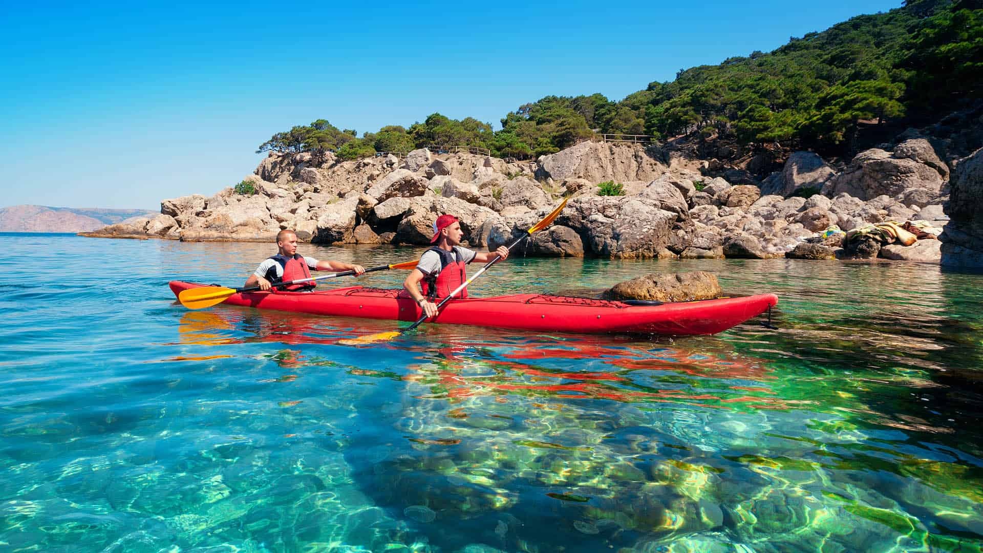 Kayaking: A couple of kayakers in the Adriatic Sea, Croatia extended water trips. 1920x1080 Full HD Background.