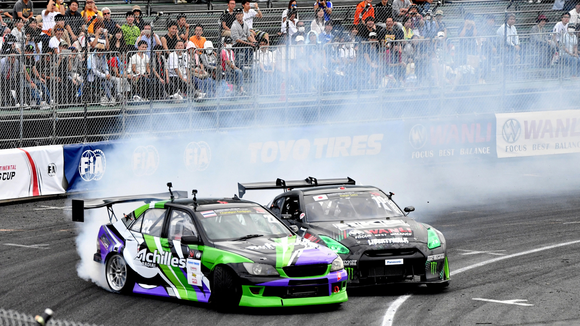 Drifting: Nissan GT-R, Achilles Radial, Japan vs. Thailand, Competitive motorsports event. 2000x1130 HD Background.