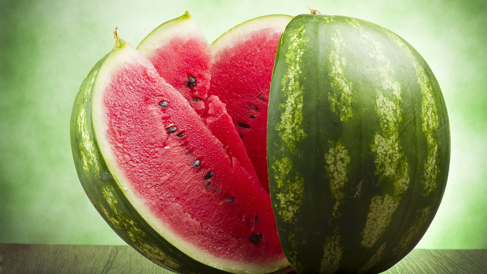 Watermelon: A large, round, or oval-shaped fruit with dark green skin, sweet pink flesh, and a lot of black seeds. 1920x1080 Full HD Background.