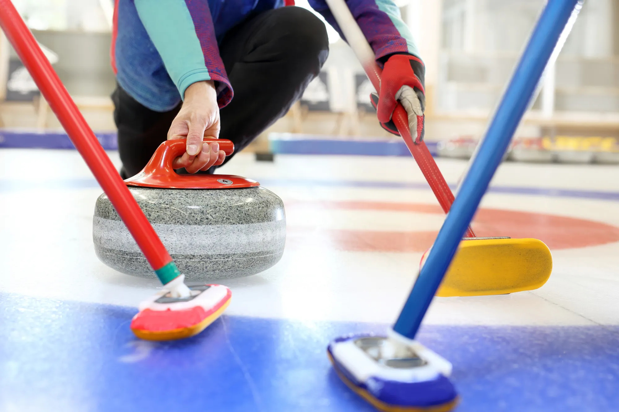 Curling: A rock and three brooms on the ice, Equipment for a winter sport. 2000x1340 HD Background.