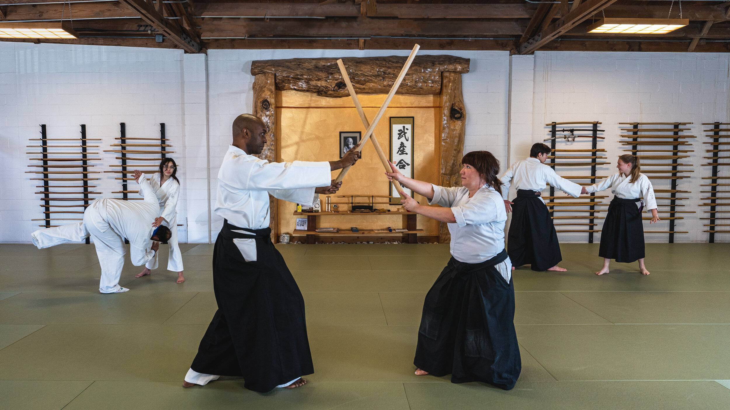 Aikido: Kenjutsu style, Kata training, Dojo sparring with the use of wooden bokuto. 2500x1410 HD Background.