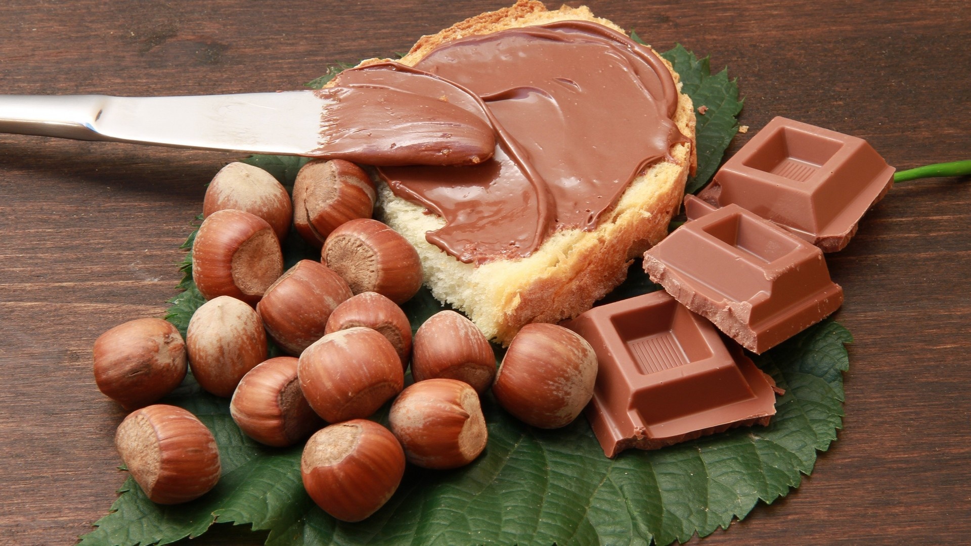 Hazelnuts: Nutella is a popular industrial cream made of filberts. 1920x1080 Full HD Background.