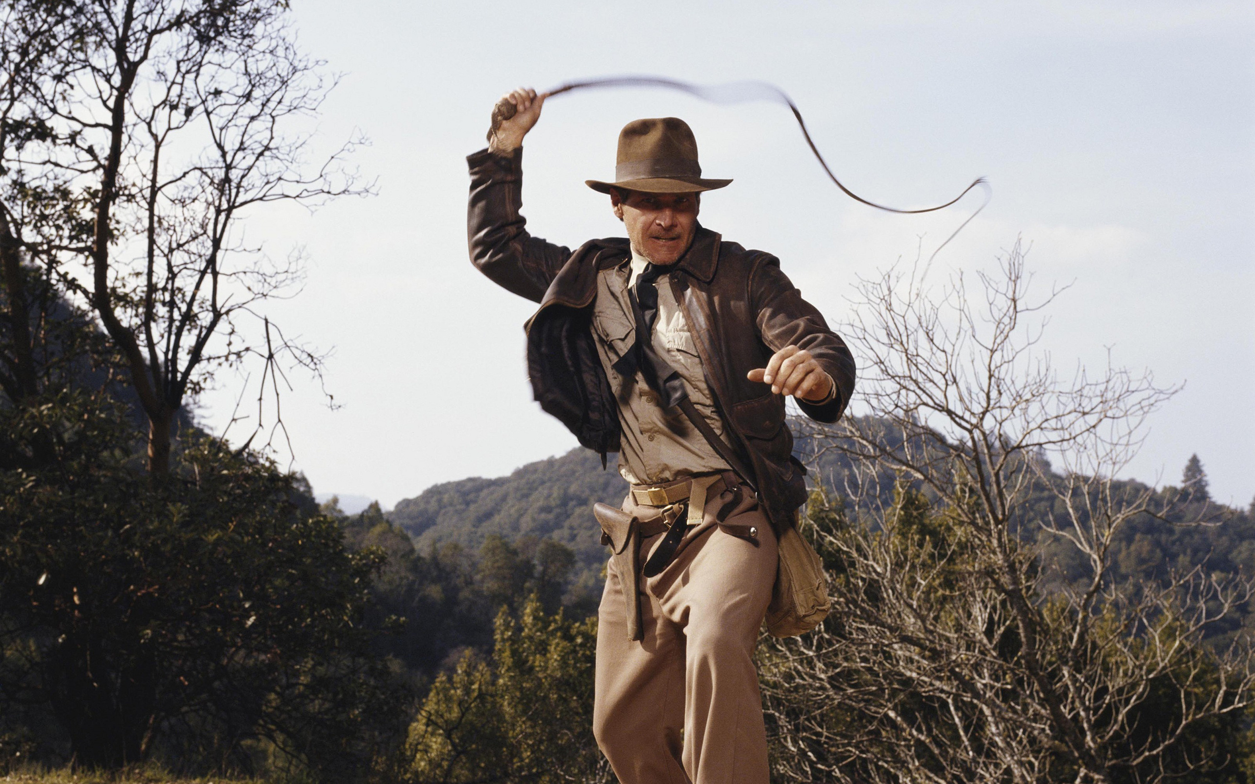 Harrison Ford (Indiana Jones): Character designer Jim Steranko provided Jones with his iconic flight jacket, fedora, and bullwhip. 2560x1600 HD Background.