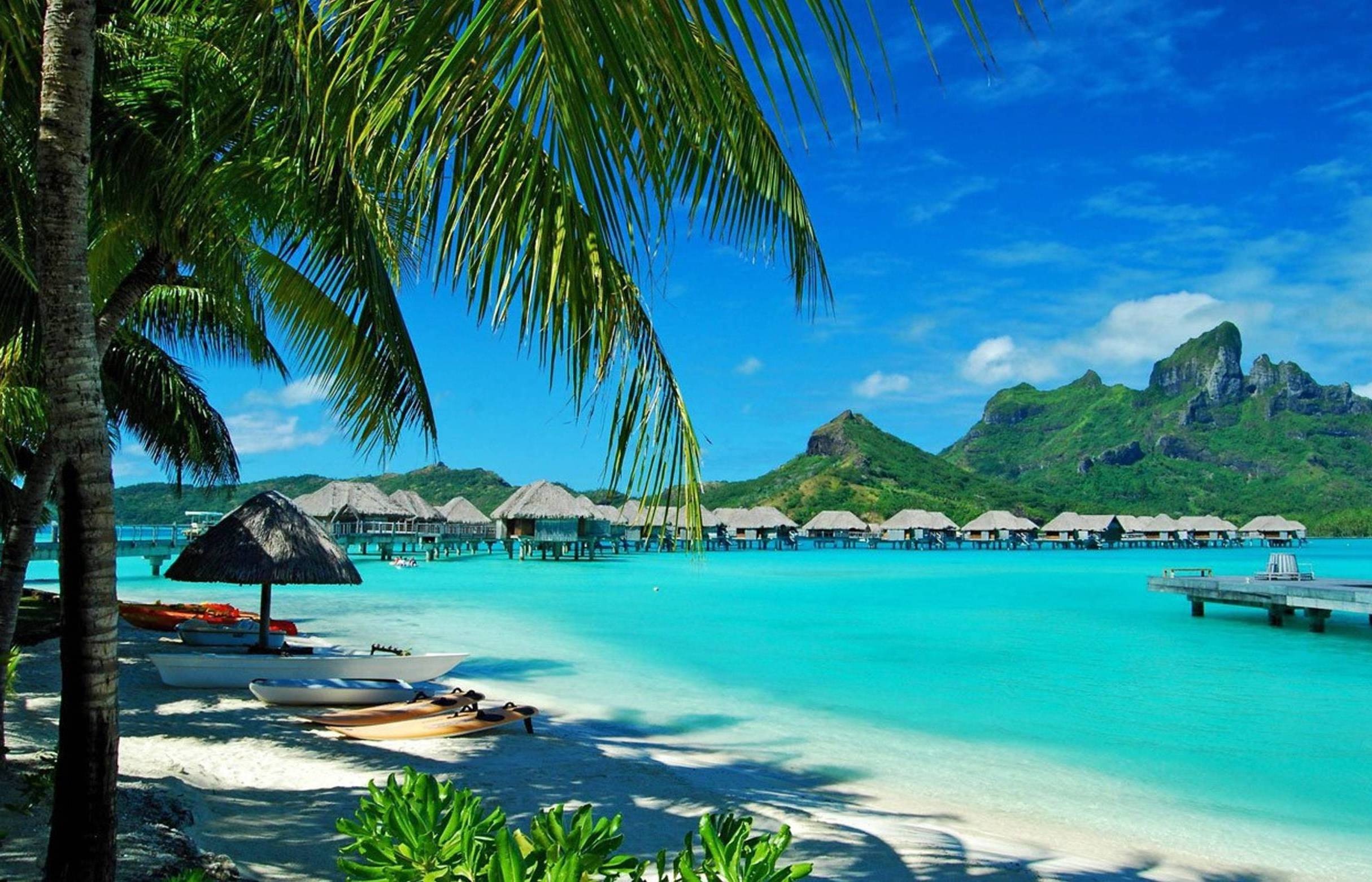 Bora Bora: Guest bungalows are perched over the water on stilts, Beach vacations spots. 2430x1570 HD Background.