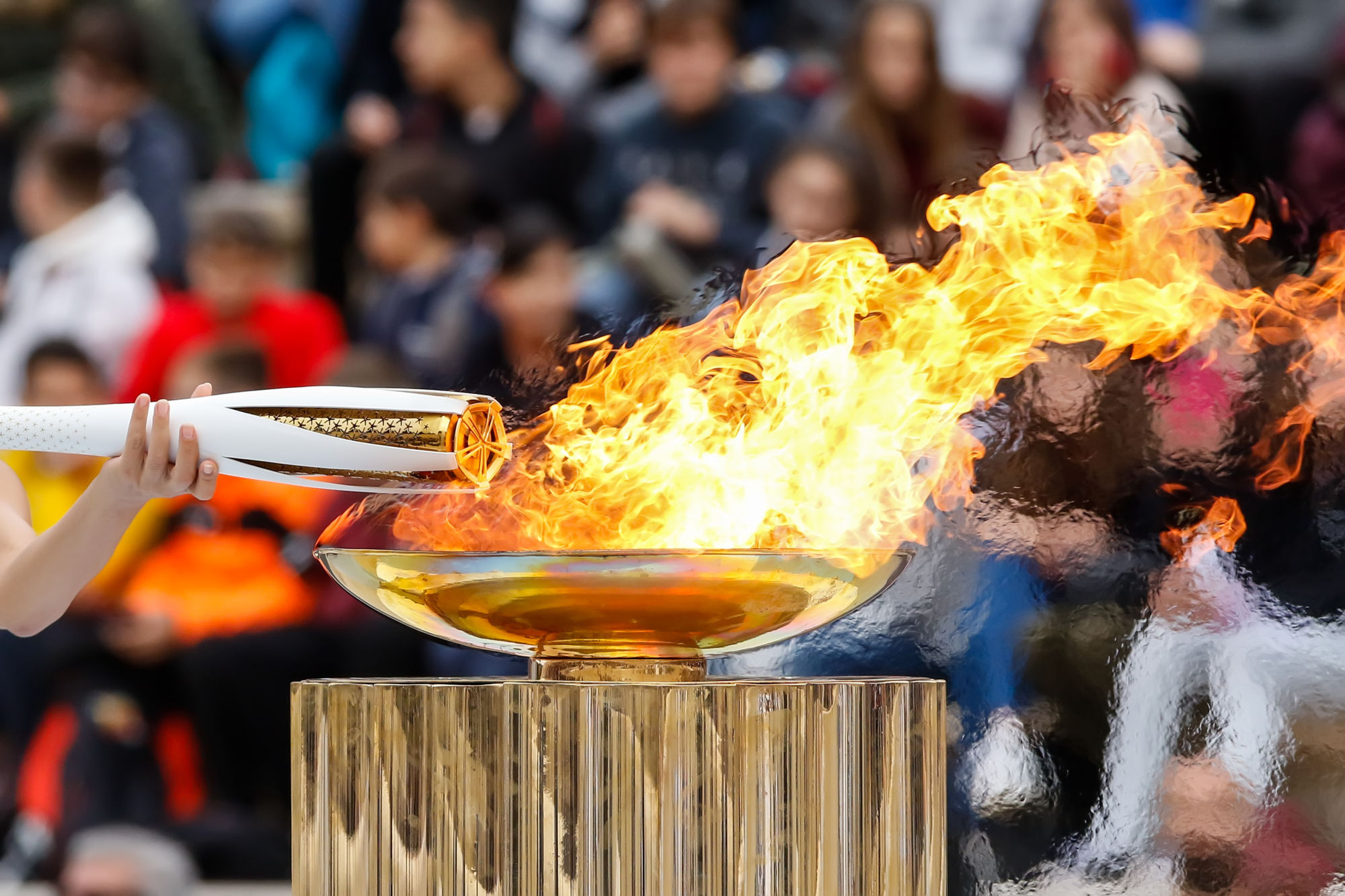 Olympic Flame: Lighting the torch with the flame, The Olympic flame handover ceremony, Symbolic sports tradition. 2000x1340 HD Wallpaper.