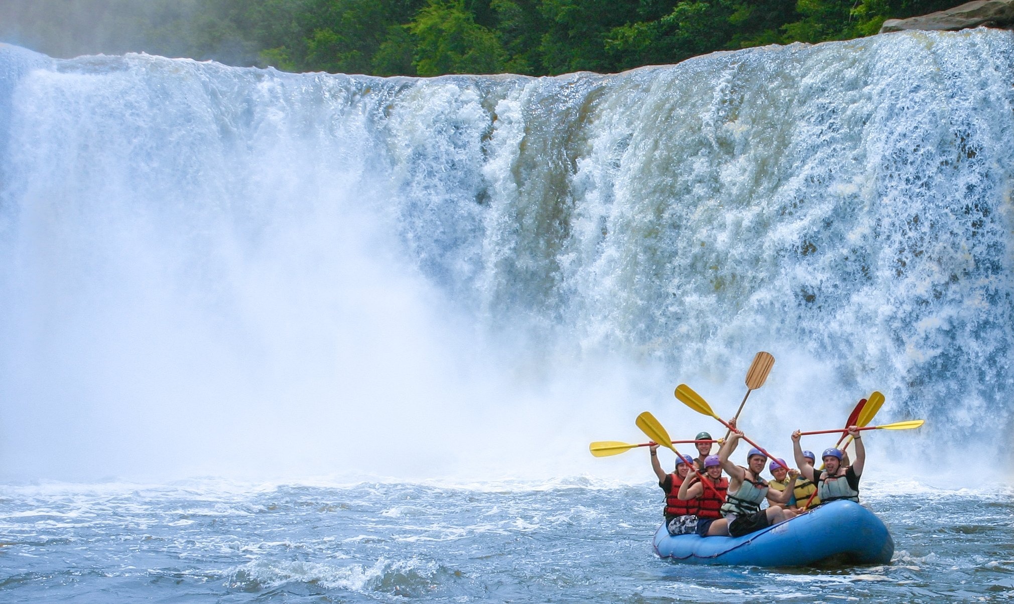 Rafting: An extreme whitewater boating activity near the waterfall. 2020x1210 HD Background.
