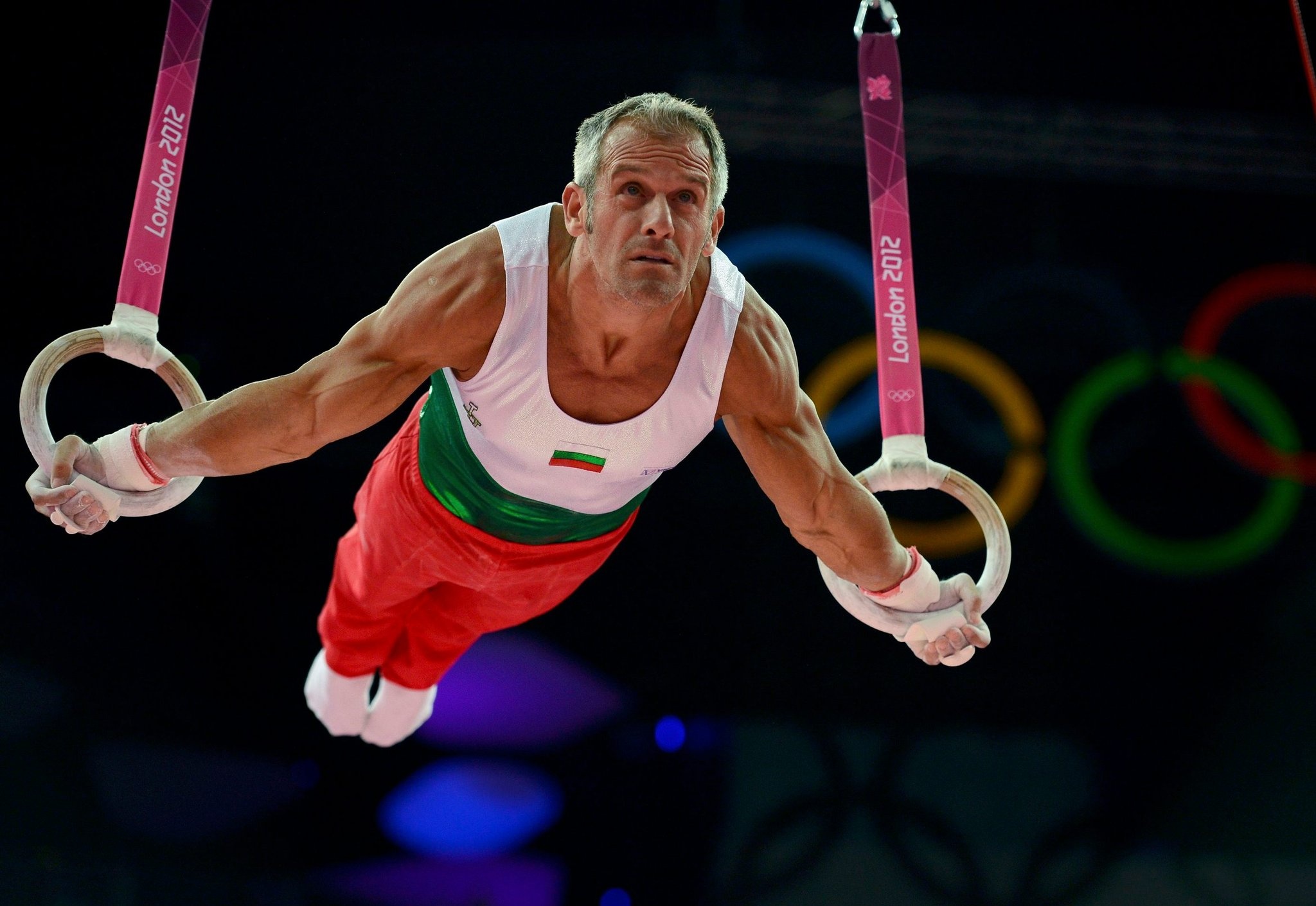 Rings (Gymnastics): Strength training, Yordan Yovchev, Bulgarian gymnast. 2050x1420 HD Background.