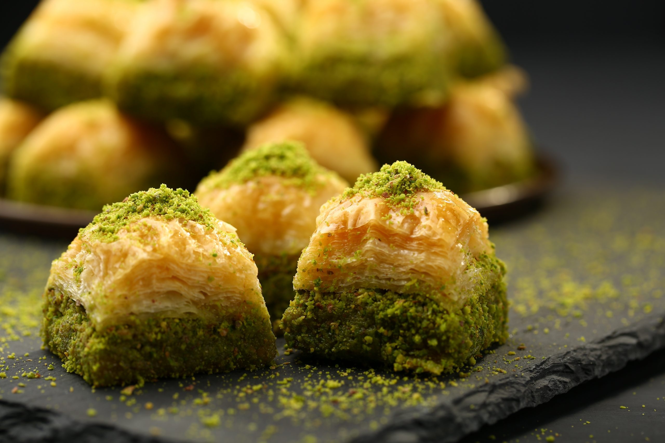 Baklava: Sheets of phyllo are layered in a baking pan with finely chopped nuts. 2560x1710 HD Background.