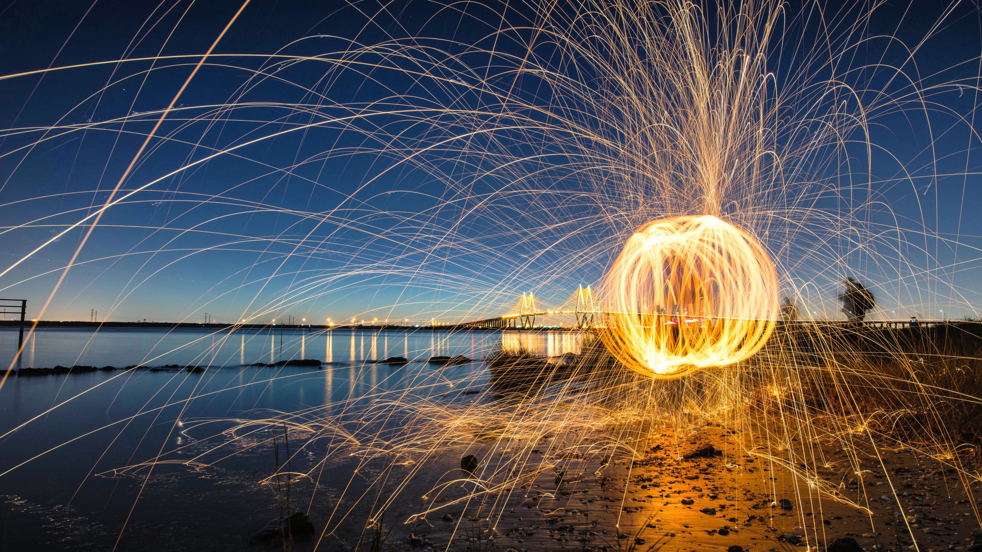 Gold Lights: Fireworks at the ocean beach, Golden ball-shaped lights, Atmospheric. 3840x2160 4K Wallpaper.