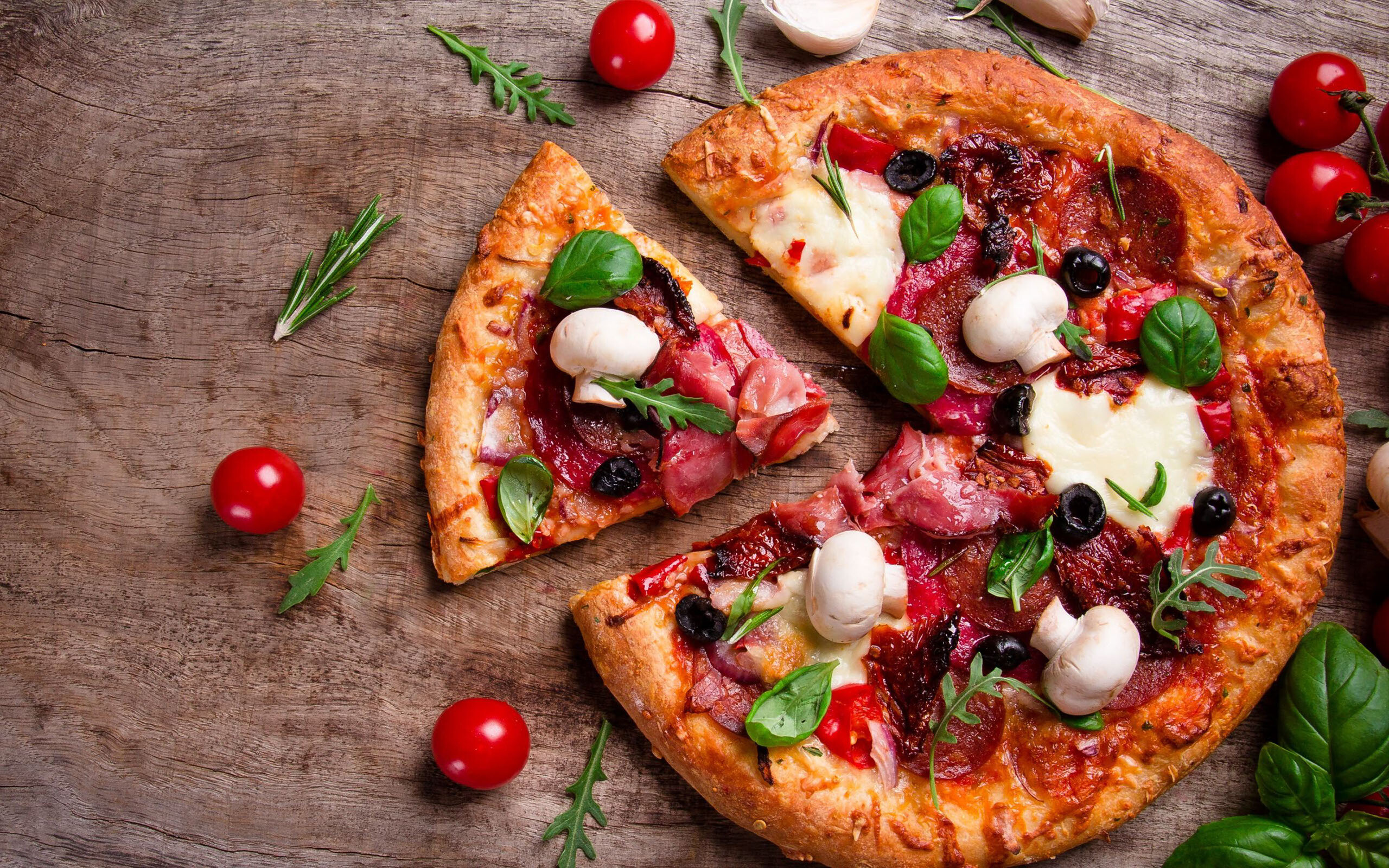 Pizza: A flat round base of dough baked with a topping of tomatoes and cheese. 2560x1600 HD Background.