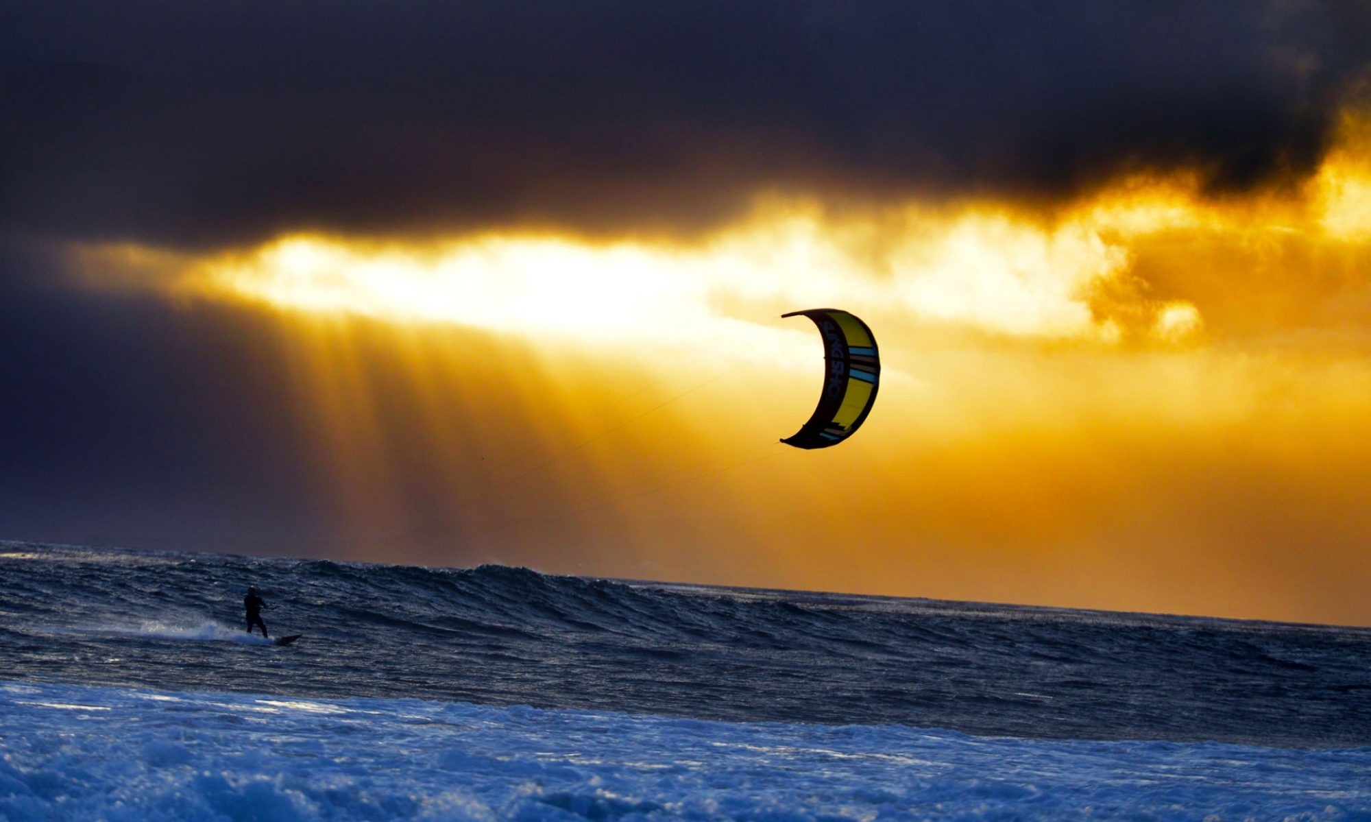 Kiteboarding: Kitesurfing at sunset, Riding waves, Wind speed. 2000x1200 HD Wallpaper.