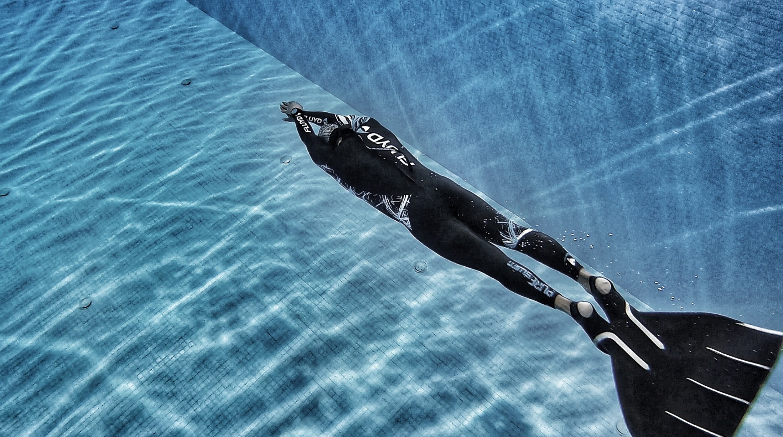 Freediving: Breath-hold swimming with a monofin training session in the swimming pool. 2500x1400 HD Wallpaper.