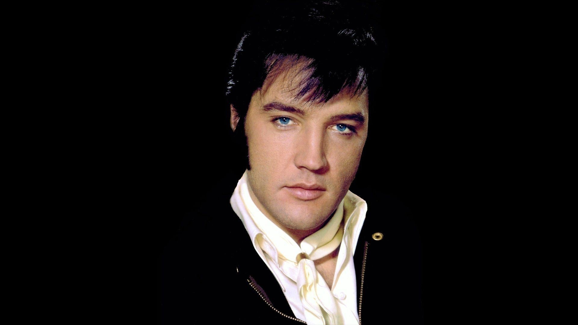 Elvis Presley: His discography is studded with classics including ‘All Shook Up’, ‘Can’t Help Falling in Love’, ‘Jailhouse Rock’. 1920x1080 Full HD Background.