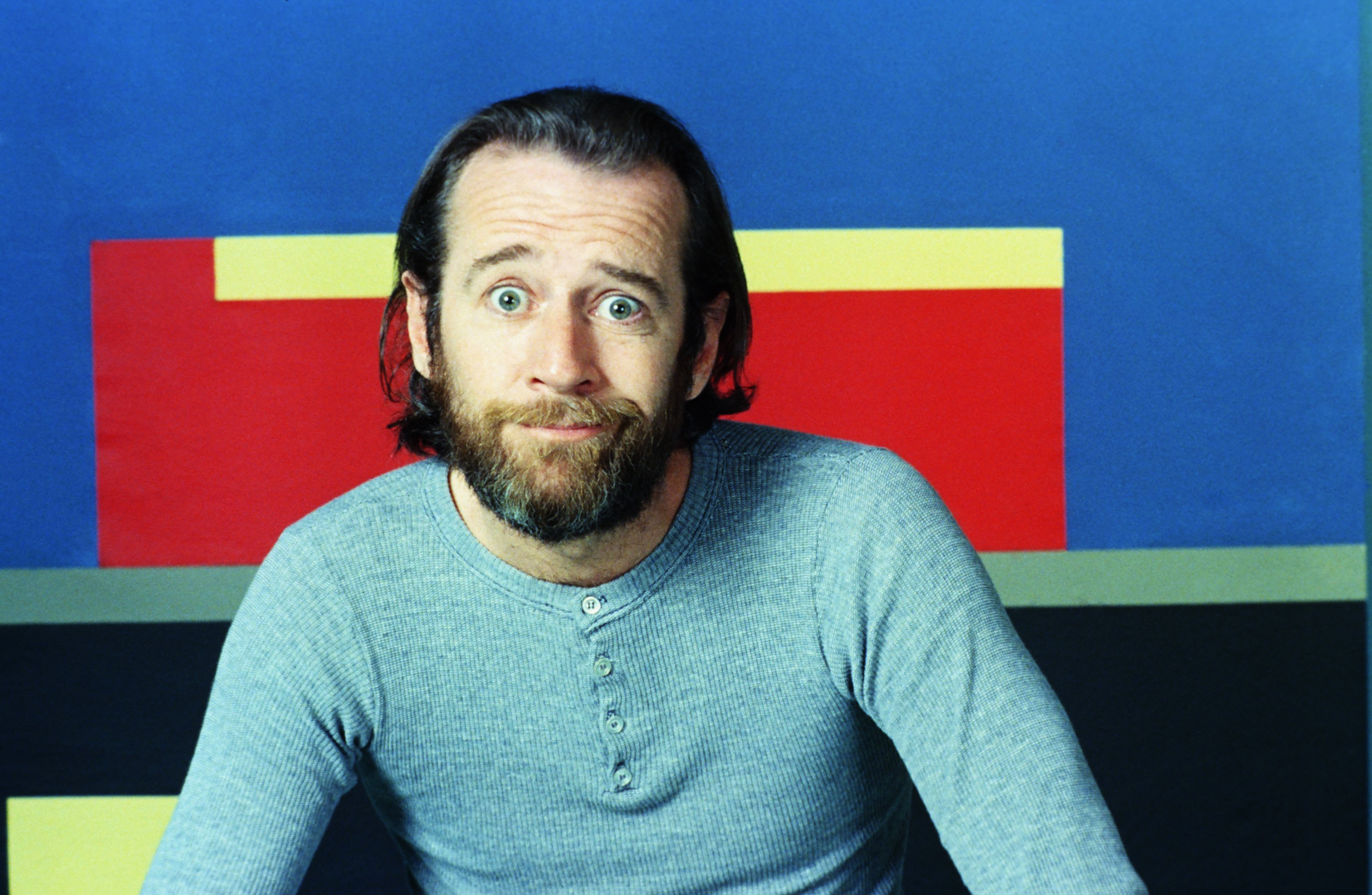 George Carlin: An American comedian, actor, author, and social critic. 3000x1960 HD Background.