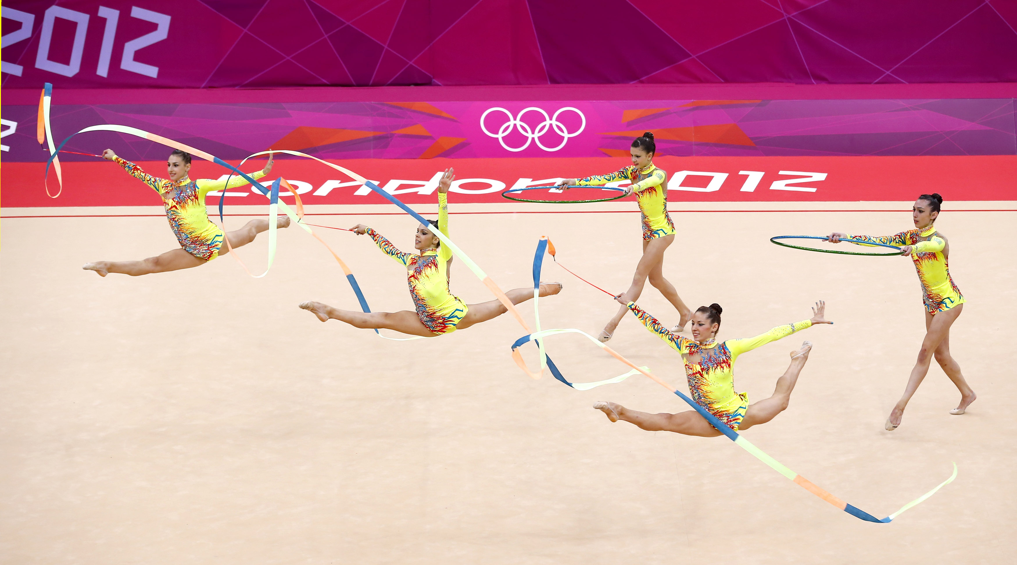 Rhythmic Gymnastics: A group performance at the 2012 London Summer Olympics. 3500x1950 HD Background.