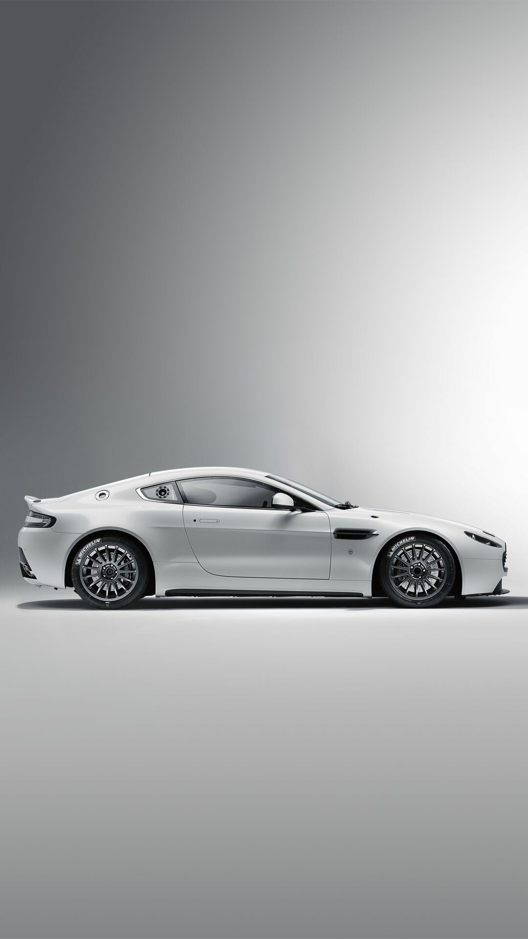 Aston Martin: A British company known worldwide for its creation and production of luxury sports cars, AM Vantage. 1080x1920 Full HD Background.