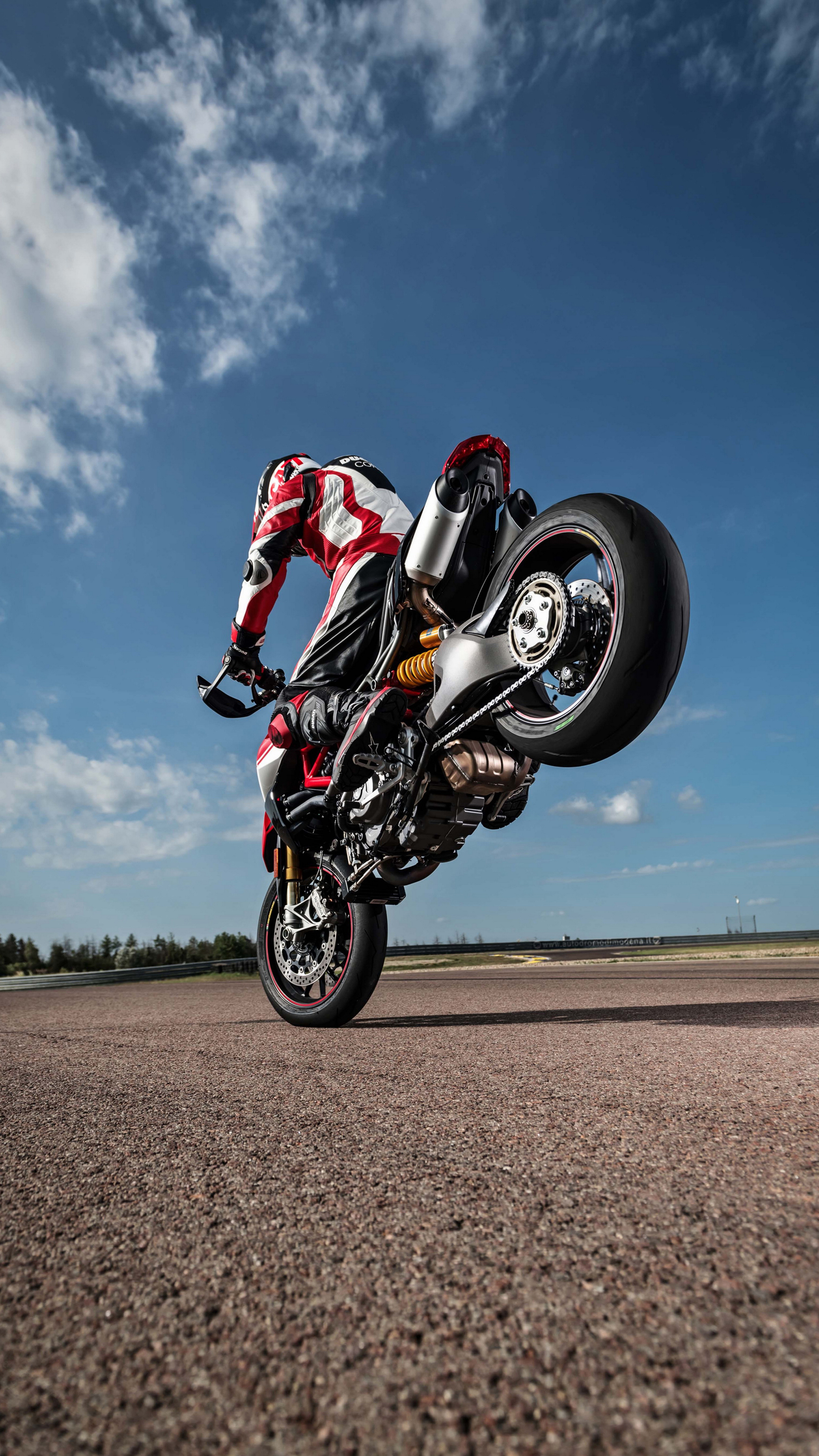 Stunt: Ducati Hypermotard 512, Sportbike, Stuntman doing a stoppie. 2160x3840 4K Background.