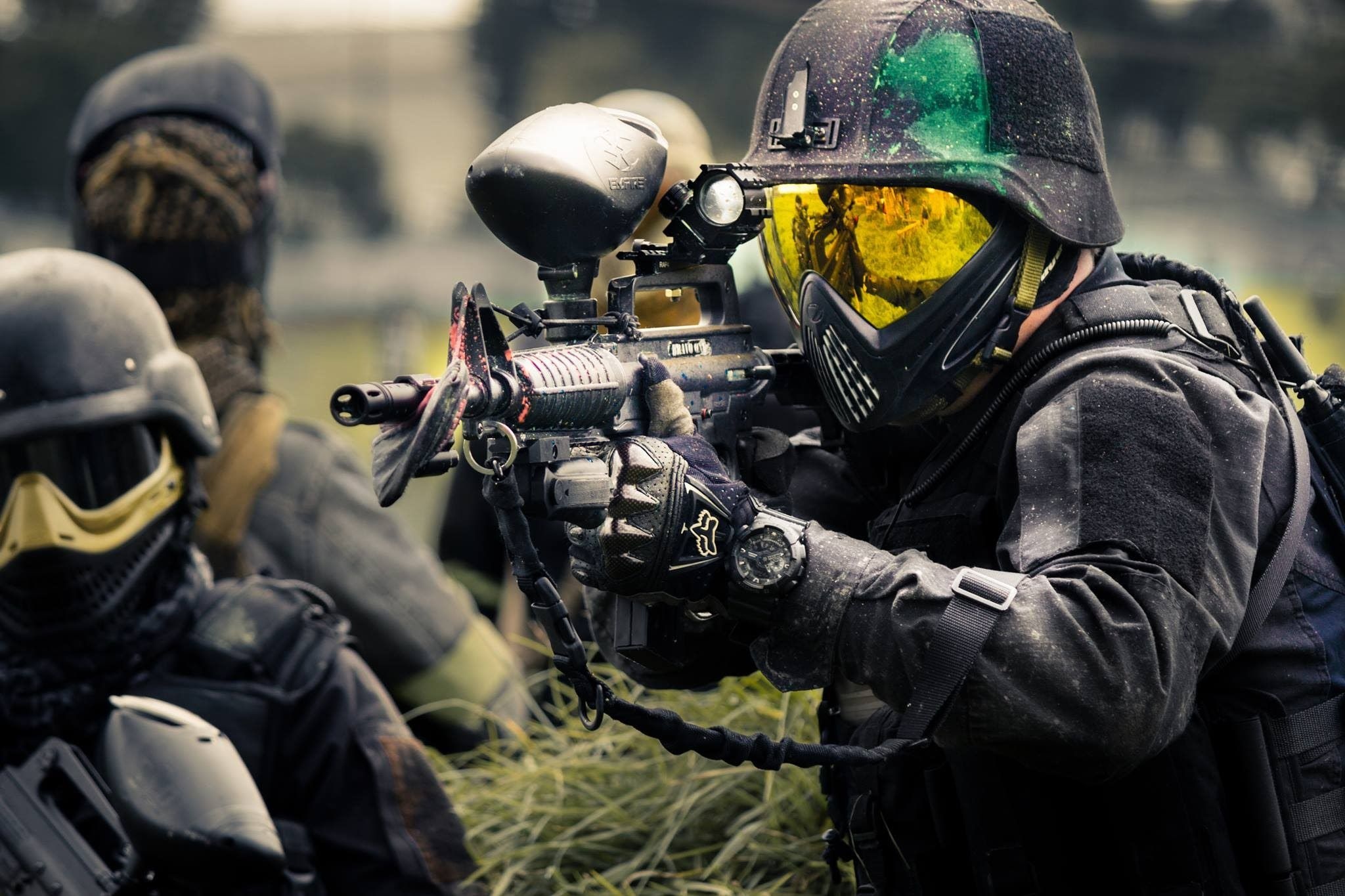 Paintball: A player equipped with a marker version of CAR15 rifle, Military combat training. 2050x1370 HD Background.
