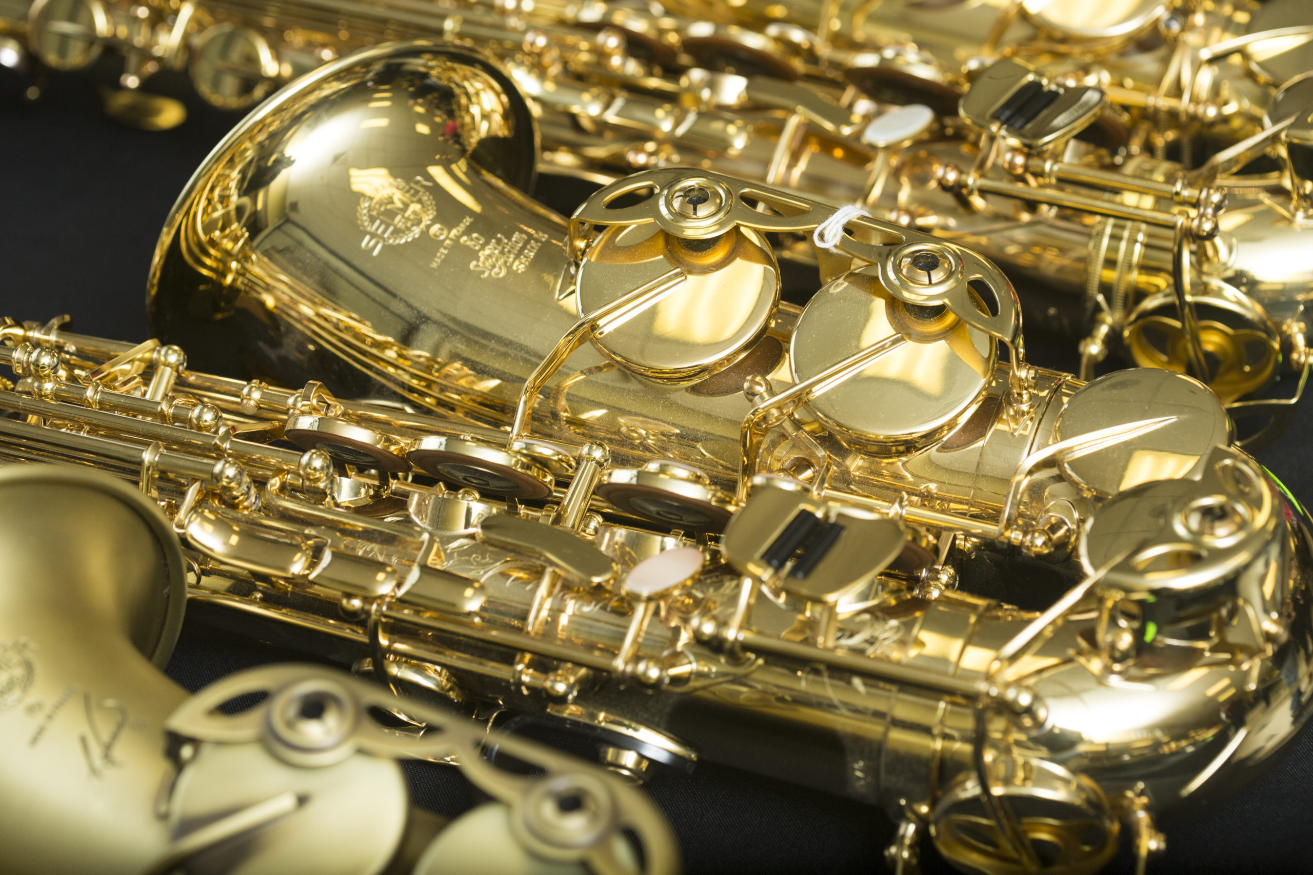 Saxophone: A woodwind instrument having a single reed conical bore and metal body. 2560x1710 HD Background.