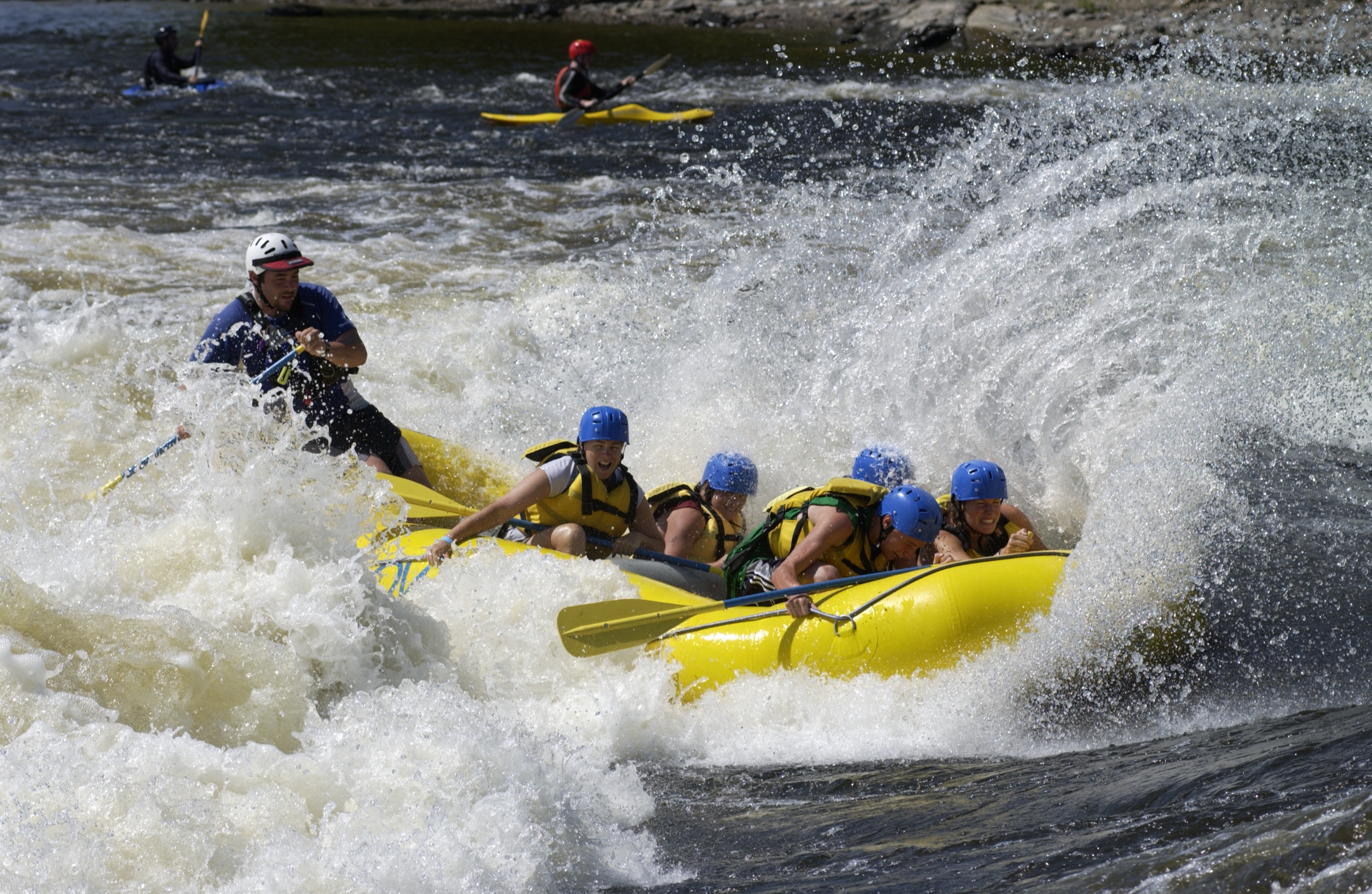 Rafting: A group of tourists moves over the rapids with a professional guide. 3010x1960 HD Background.
