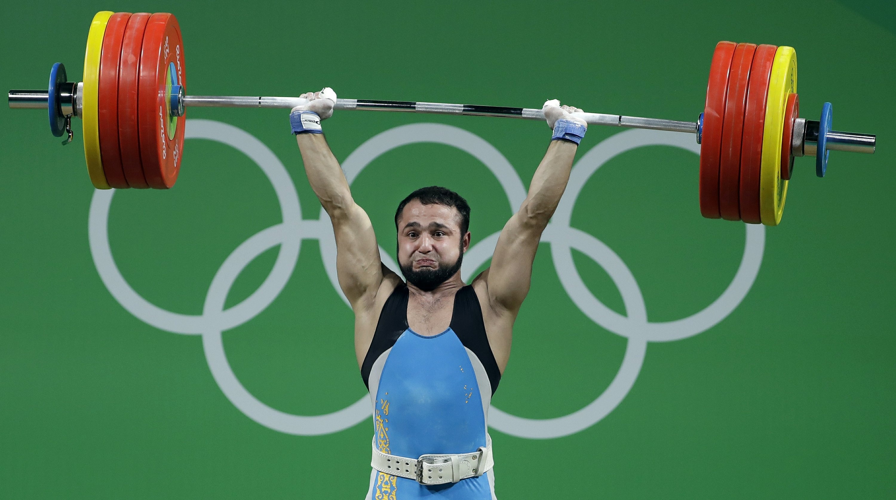 Weightlifting: Lifting a weighted barbell over the head, Paris, Olympics. 3000x1680 HD Background.