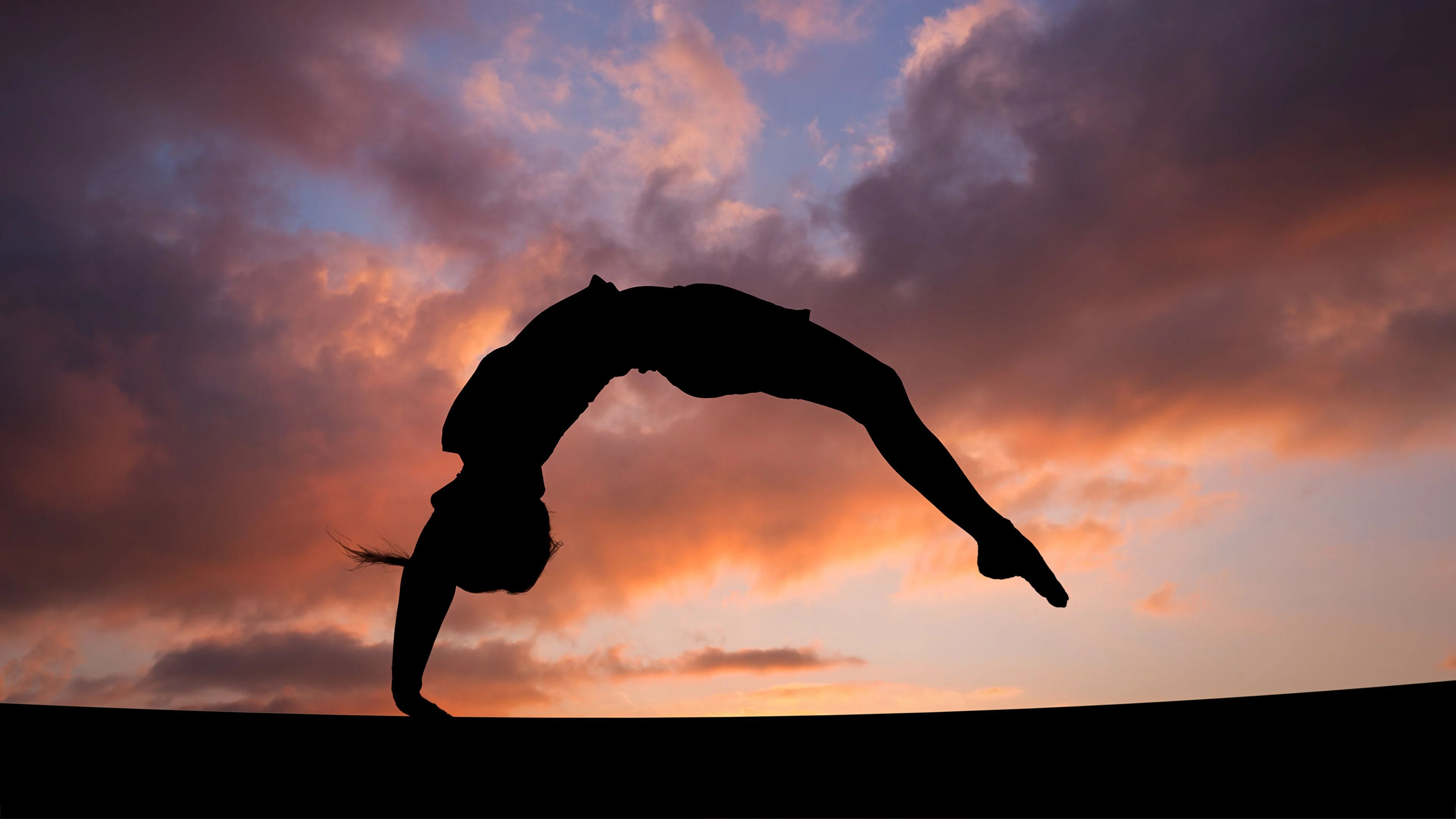Acrobatic Gymnastics: A person performs figures consisting of various moves, dance elements, stretches and tumbling. 3840x2160 4K Wallpaper.