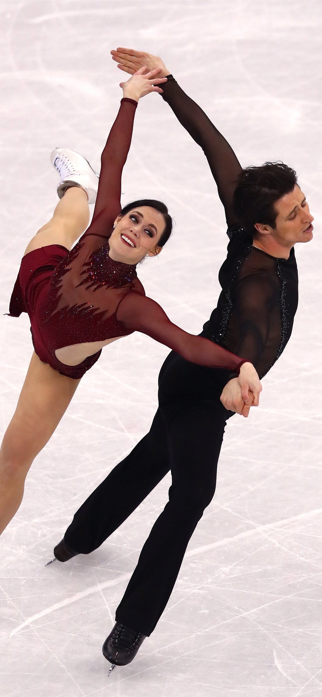 Pair Skating: Tessa Virtue and Scott Moir, Canadian ice dancers, Olympic champions at Vancouver 2010. 1290x2780 HD Background.