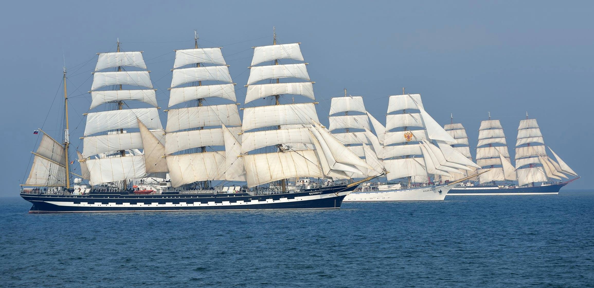 Windjammer: The grandest of merchant sailing ships, with between three and five large masts and square sails, Tartus port. 2310x1130 Dual Screen Wallpaper.