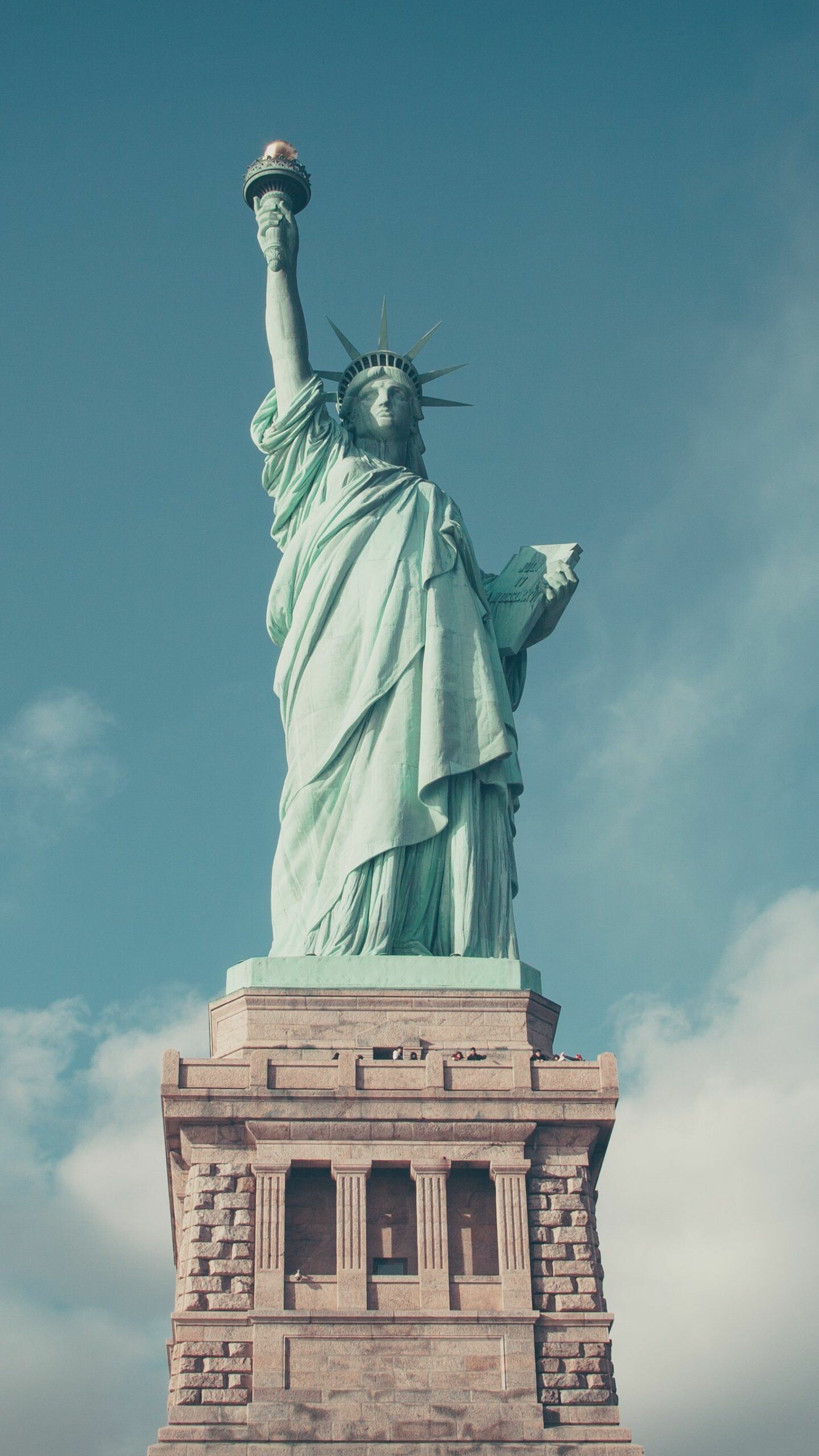 Statue of Liberty: An icon of freedom and of the United States. 1440x2560 HD Background.