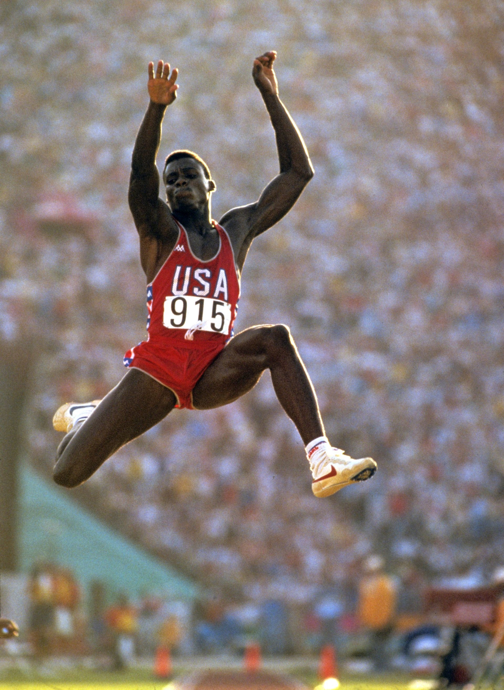 Long Jump: Sports, Carl Lewis, Los Angeles, 1984 Summer Olympics, An Athletics Championship, USA Athletic Team. 1920x2630 HD Background.