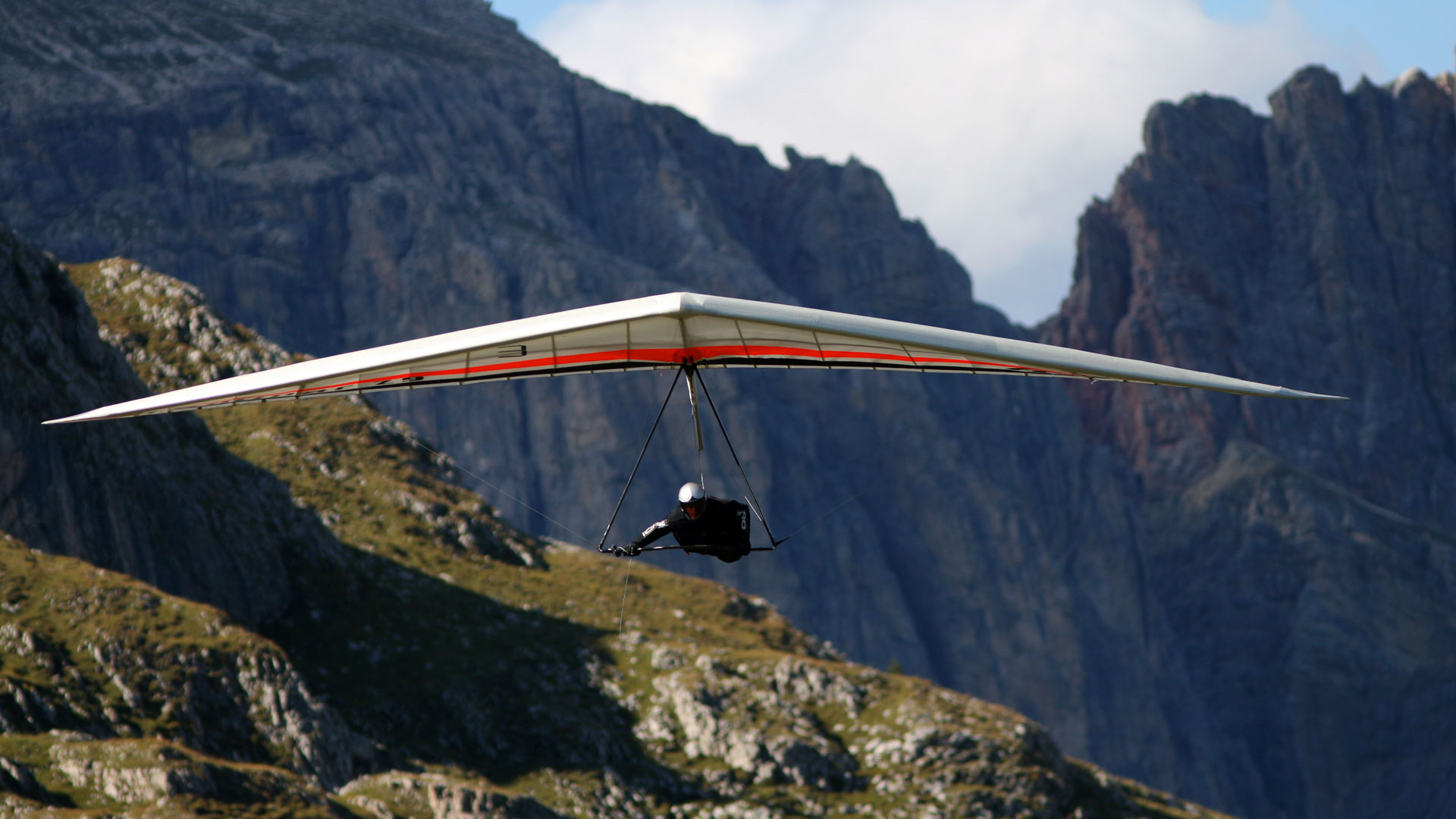 Gliding: Icaro Laminar high-wing single-place glider in the mountains, Windsports. 1920x1080 Full HD Background.