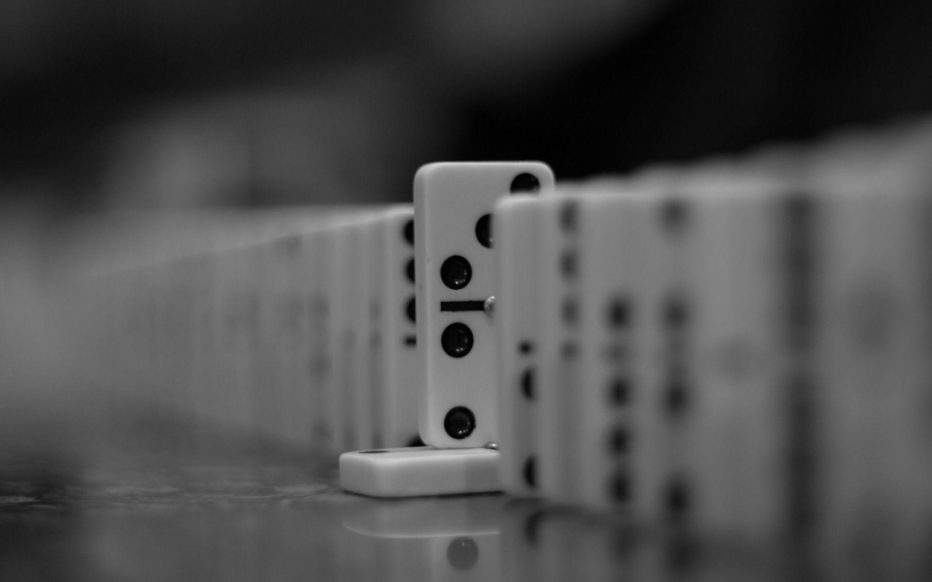 Dominoes: Monochrome tile standing on another one in the row of similar gaming bones. 1920x1200 HD Wallpaper.