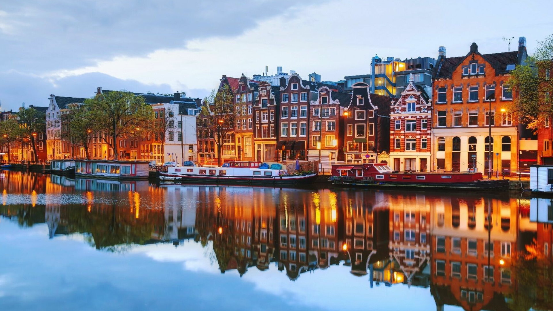 Amsterdam: The canals, used for tourism, recreation, houseboats. 1920x1080 Full HD Background.