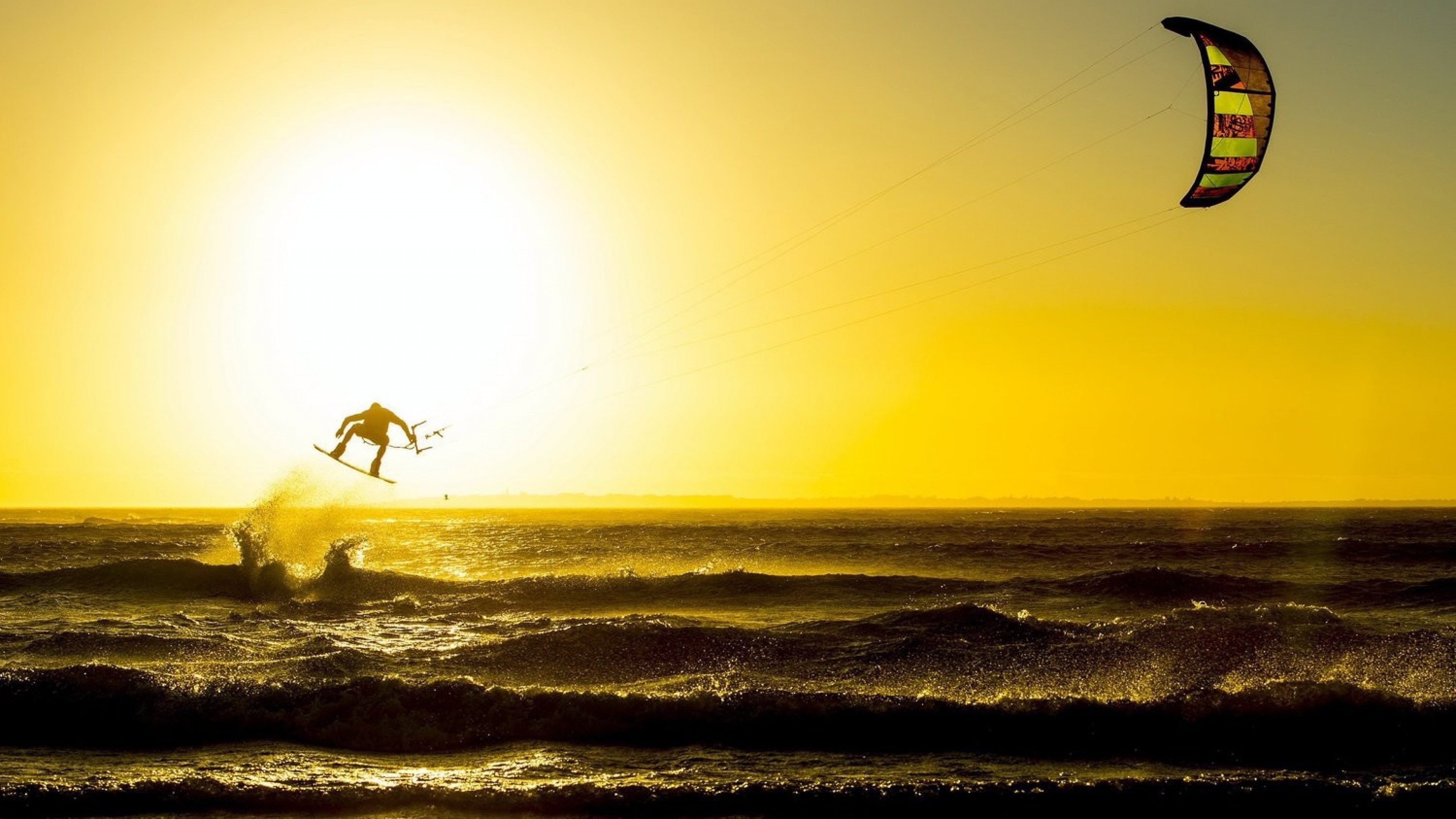 Kiteboarding: Pulling a rider across the sea, Sunset, A wake-style board. 3840x2160 HD Background.