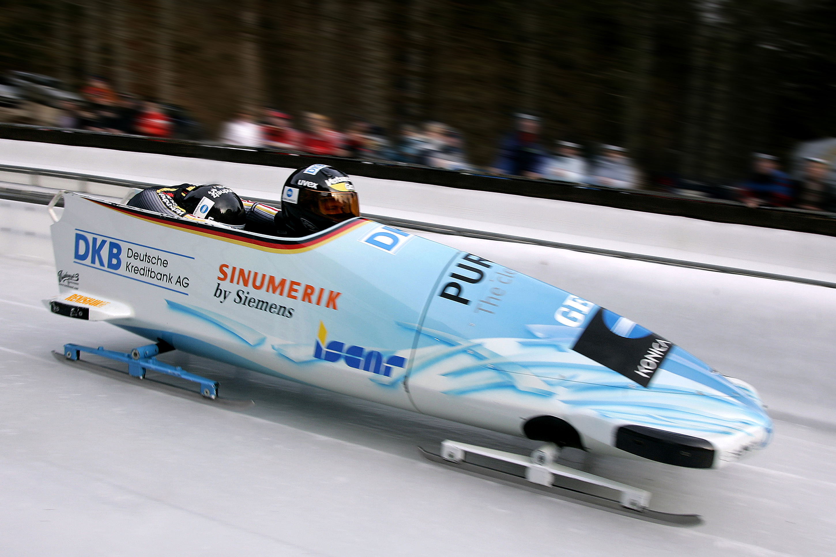 Bobsleigh: A team winter sport that involves making timed runs down narrow, twisting, banked, iced tracks in a gravity-powered sleigh. 2900x1940 HD Background.