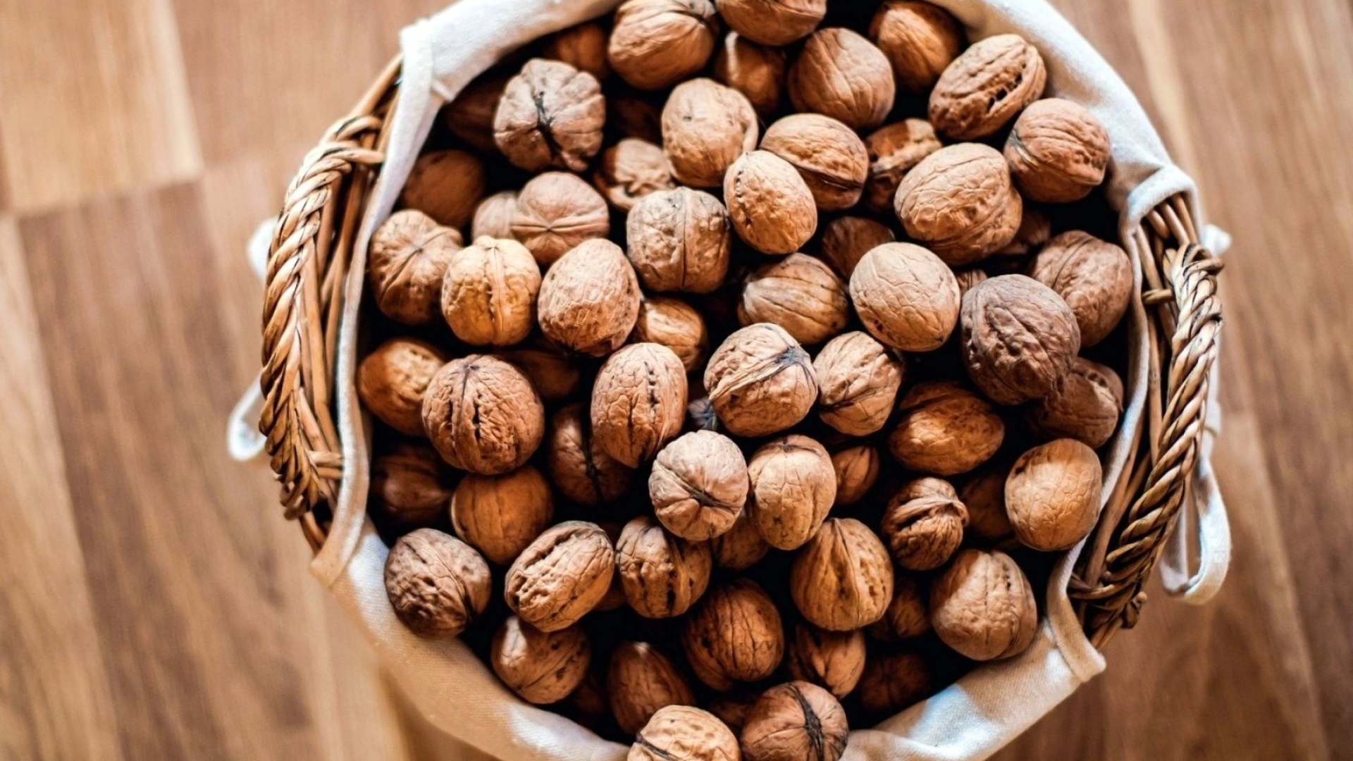 Nuts: A wrinkly, globe-like nut that is the fruit of the walnut tree. 1920x1080 Full HD Background.